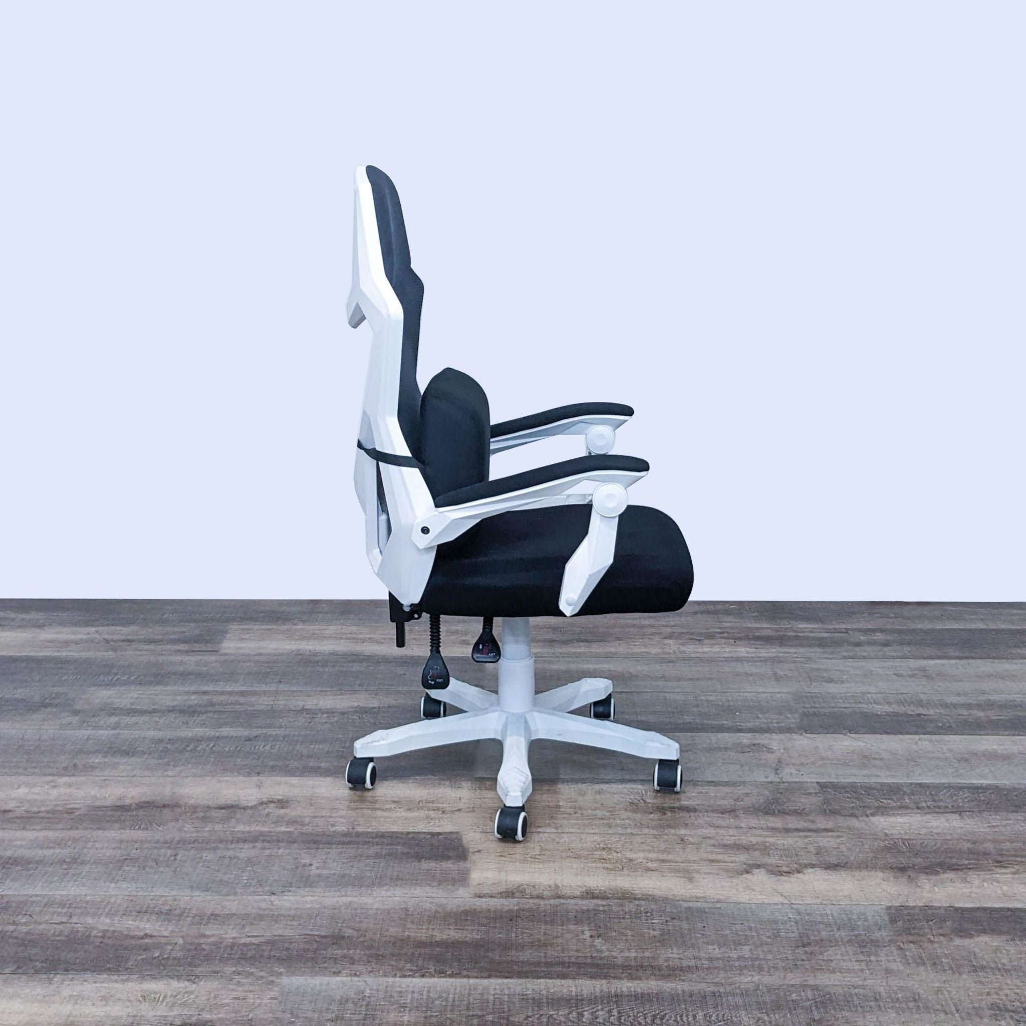 Modern black and white Reperch computer chair with recline function and removable lumbar pillow, shown from the side.