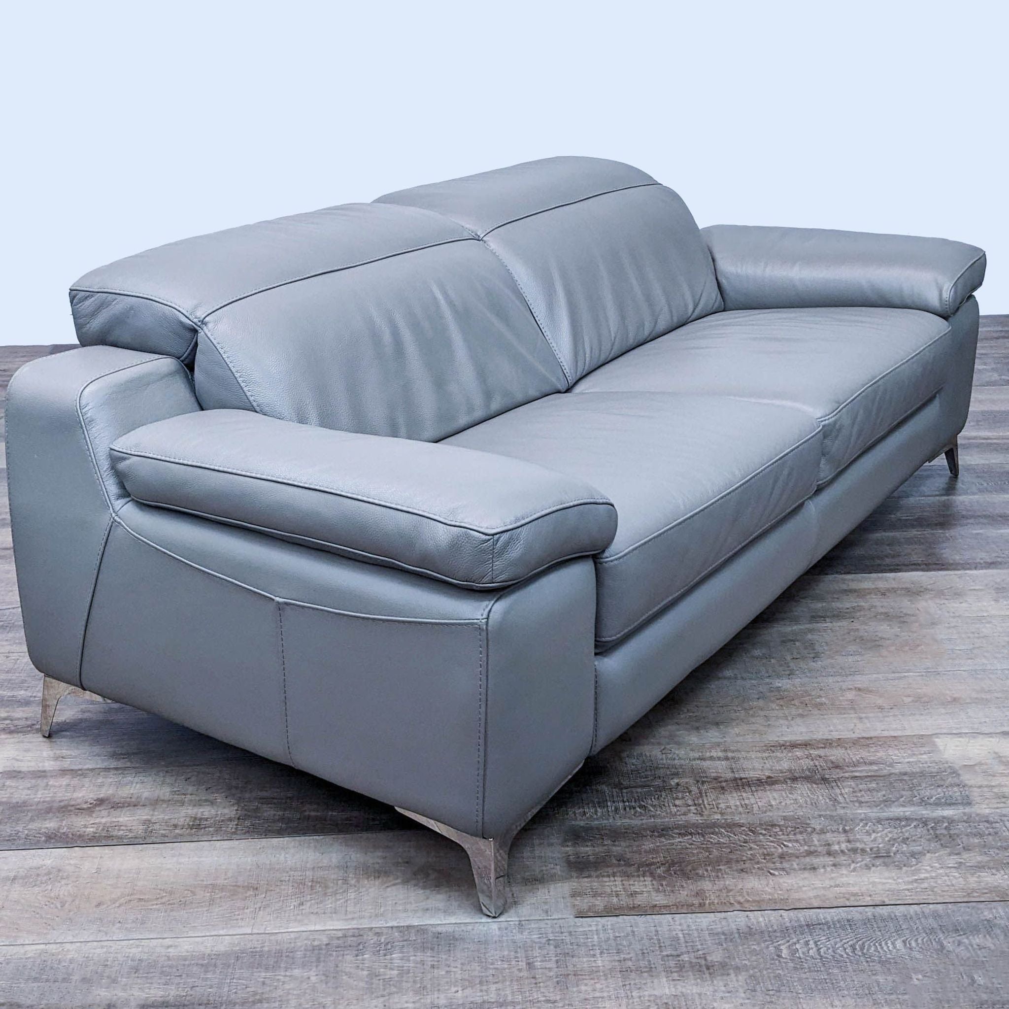 2. Modern Reperch 3-seater couch featuring adjustable backrest, plush armrests, and stylish chrome legs, partially reclined on laminate flooring.
