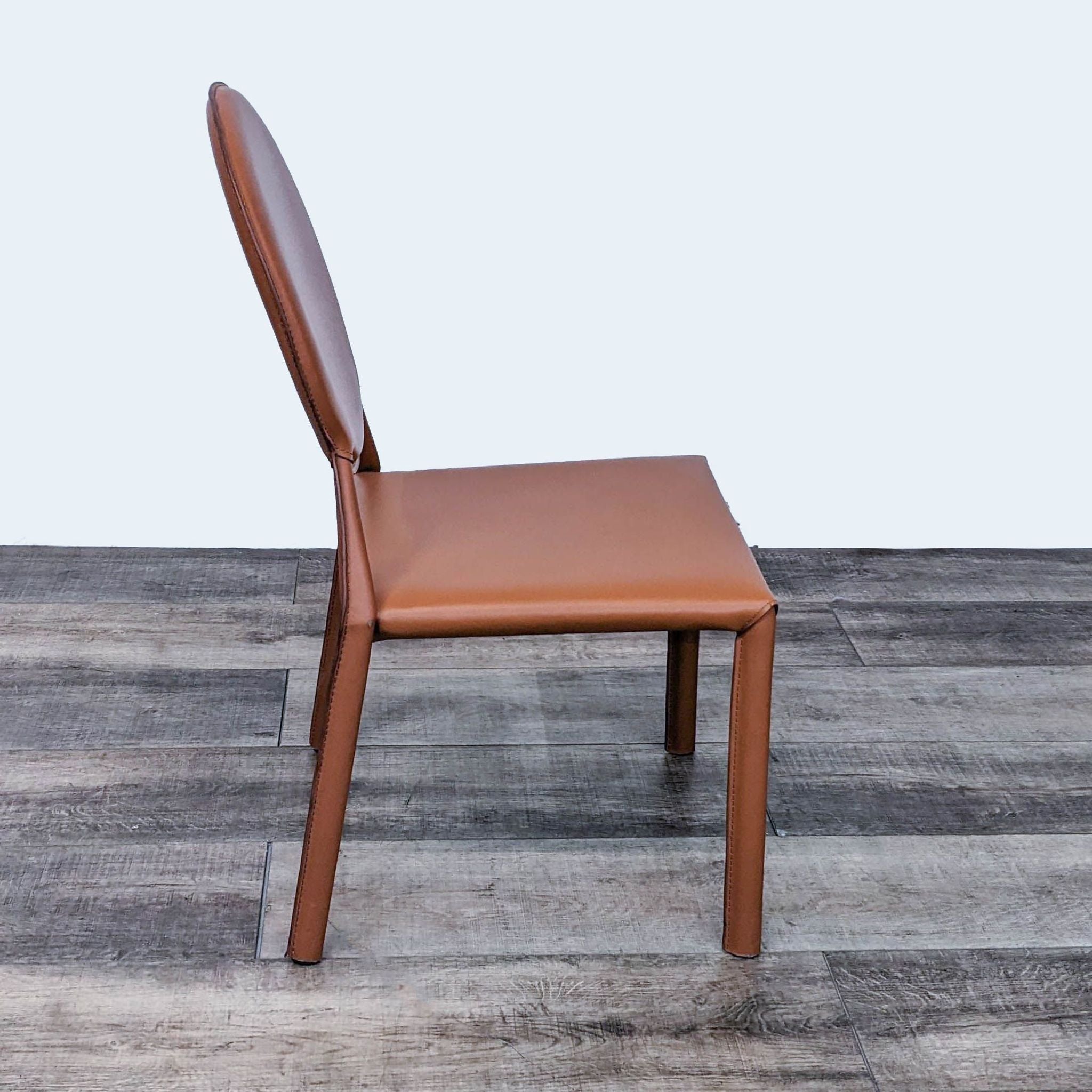 Alt text 2: Side view of the Euro Style Isabella stackable dining chair, displaying the sleek cognac leather and steel frame construction.