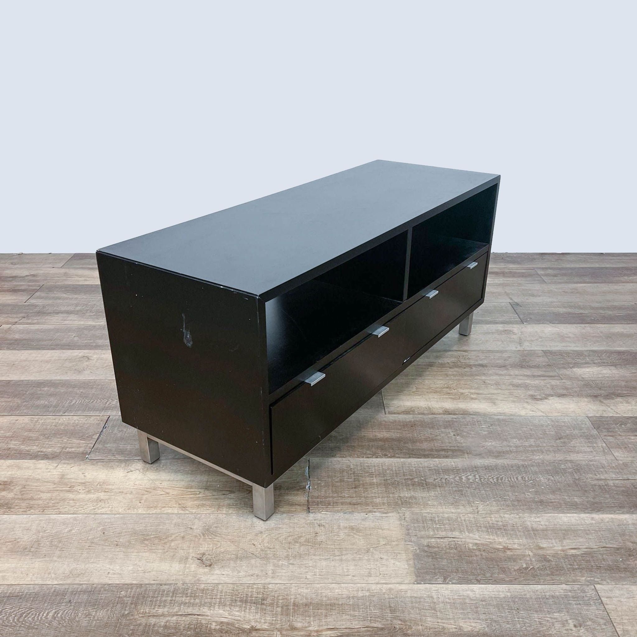 Modern Reperch entertainment unit with metallic base, including storage compartments and visible chrome handles.