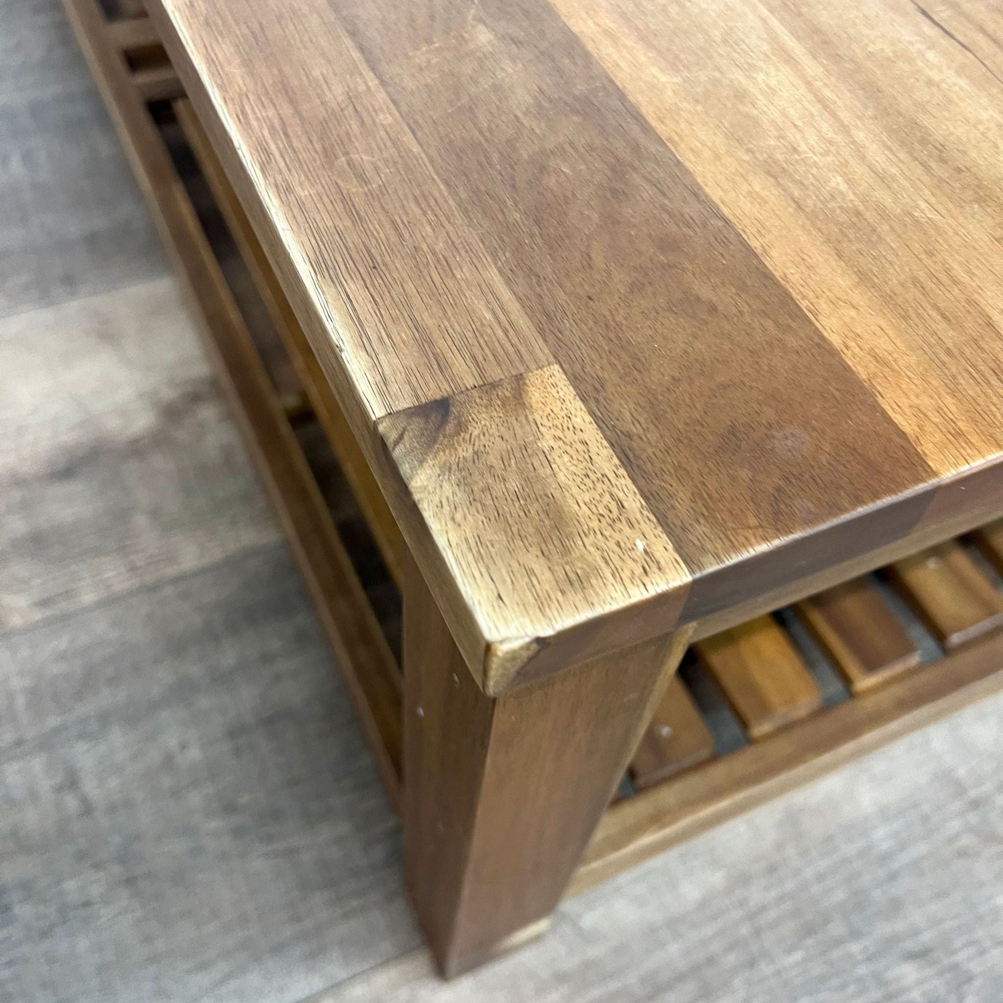 Close-up of Reperch coffee table corner showing striped wood pattern and texture.