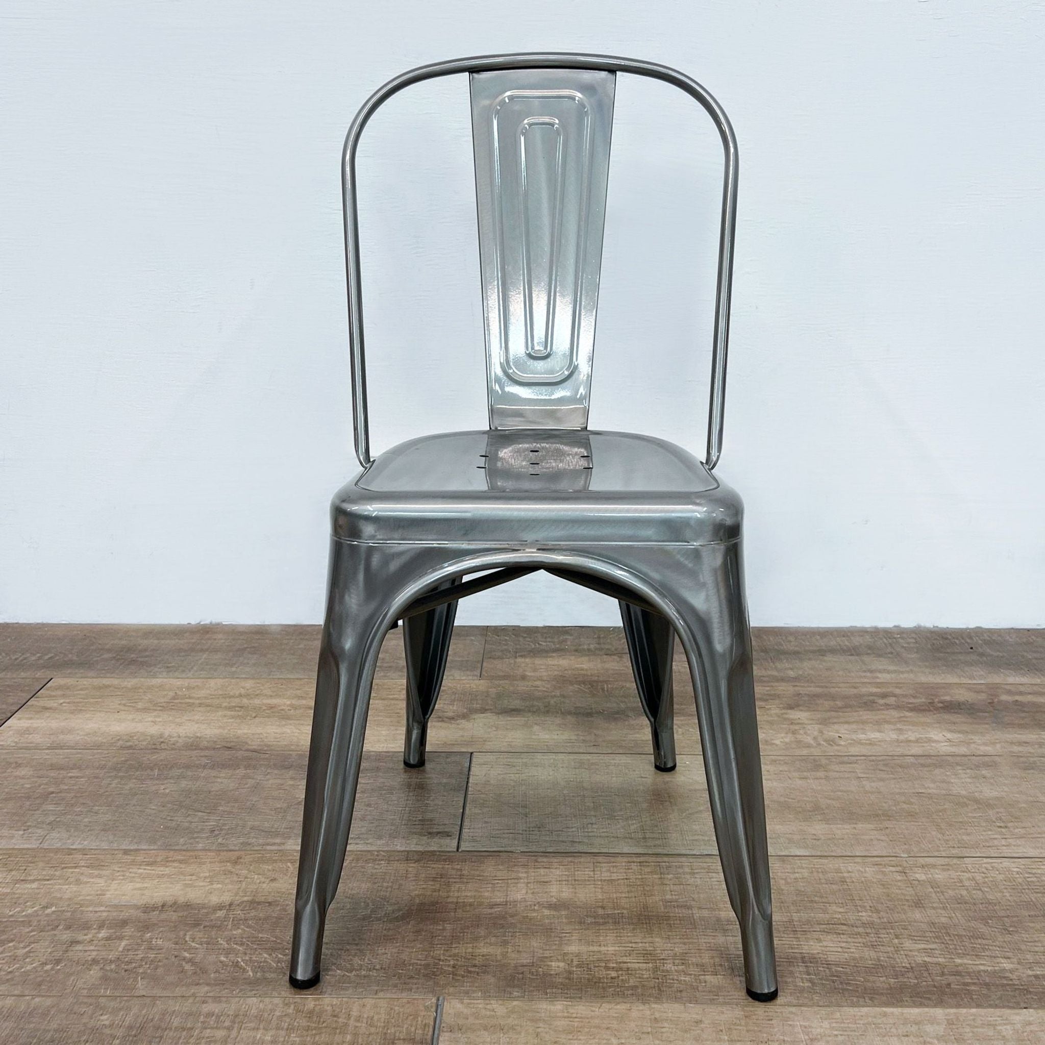 Reperch industrial metal side chair with curved back and tapered legs, suitable for indoor/outdoor use, stackable design.