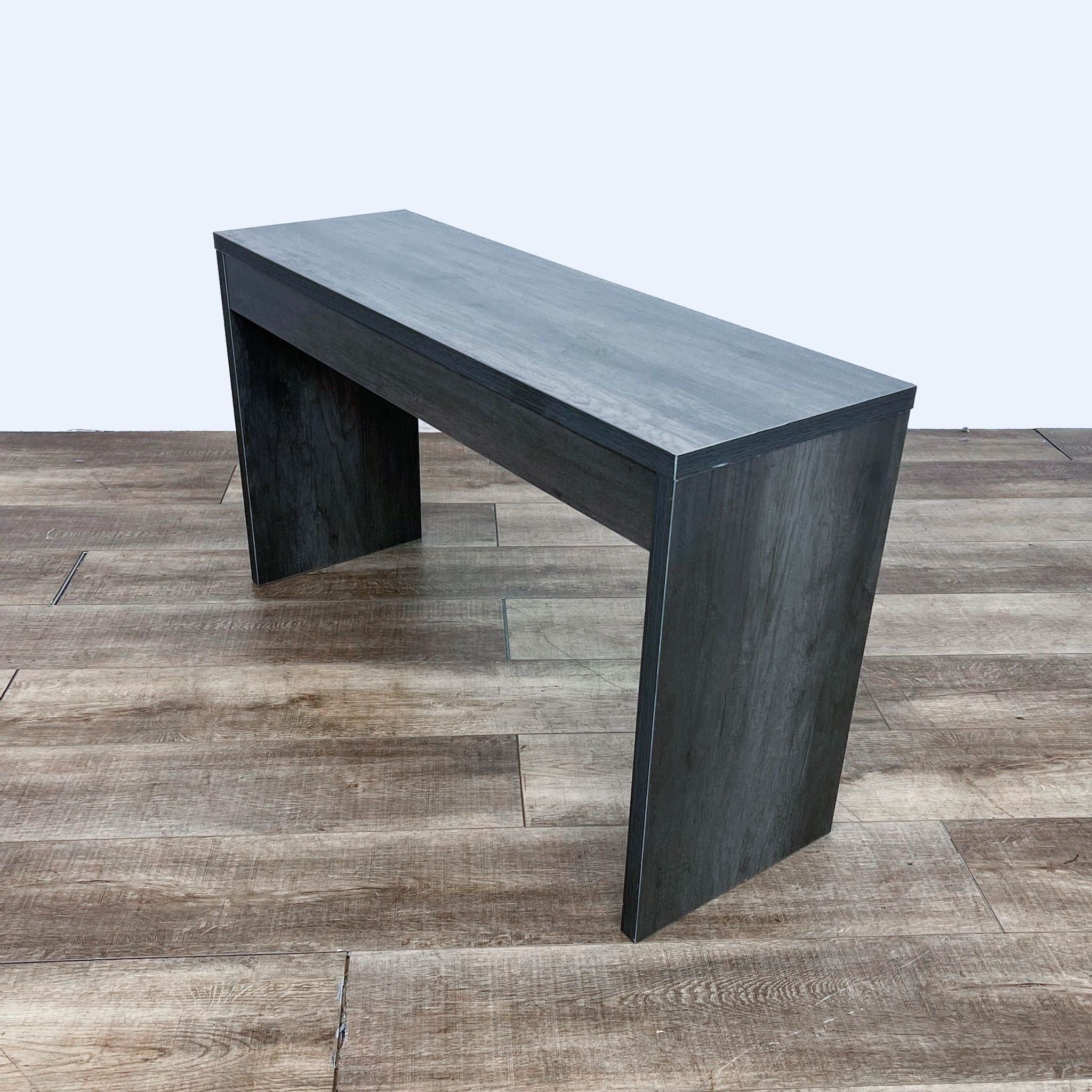 Reperch brand modern black side table with a minimalist design on wooden flooring.