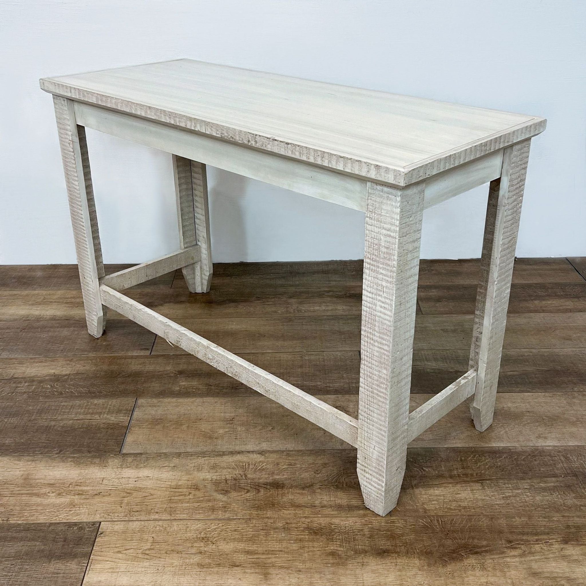 Reperch brand side table with a weathered white finish on wooden floor.