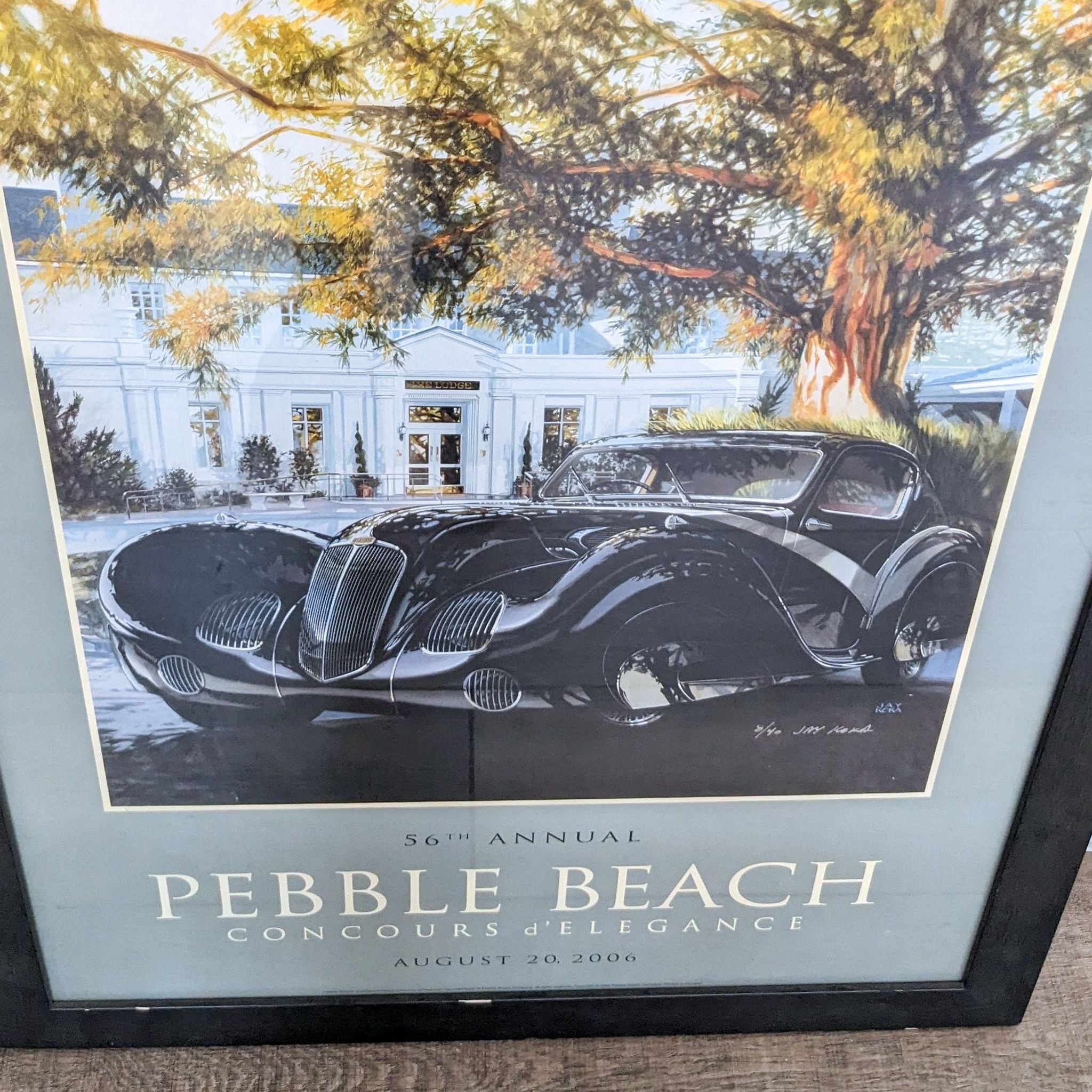 2. "Back of a framed 2006 Pebble Beach original poster depicting a Delahaye 135 Competition Sport Coupé, with hanging wire visible."