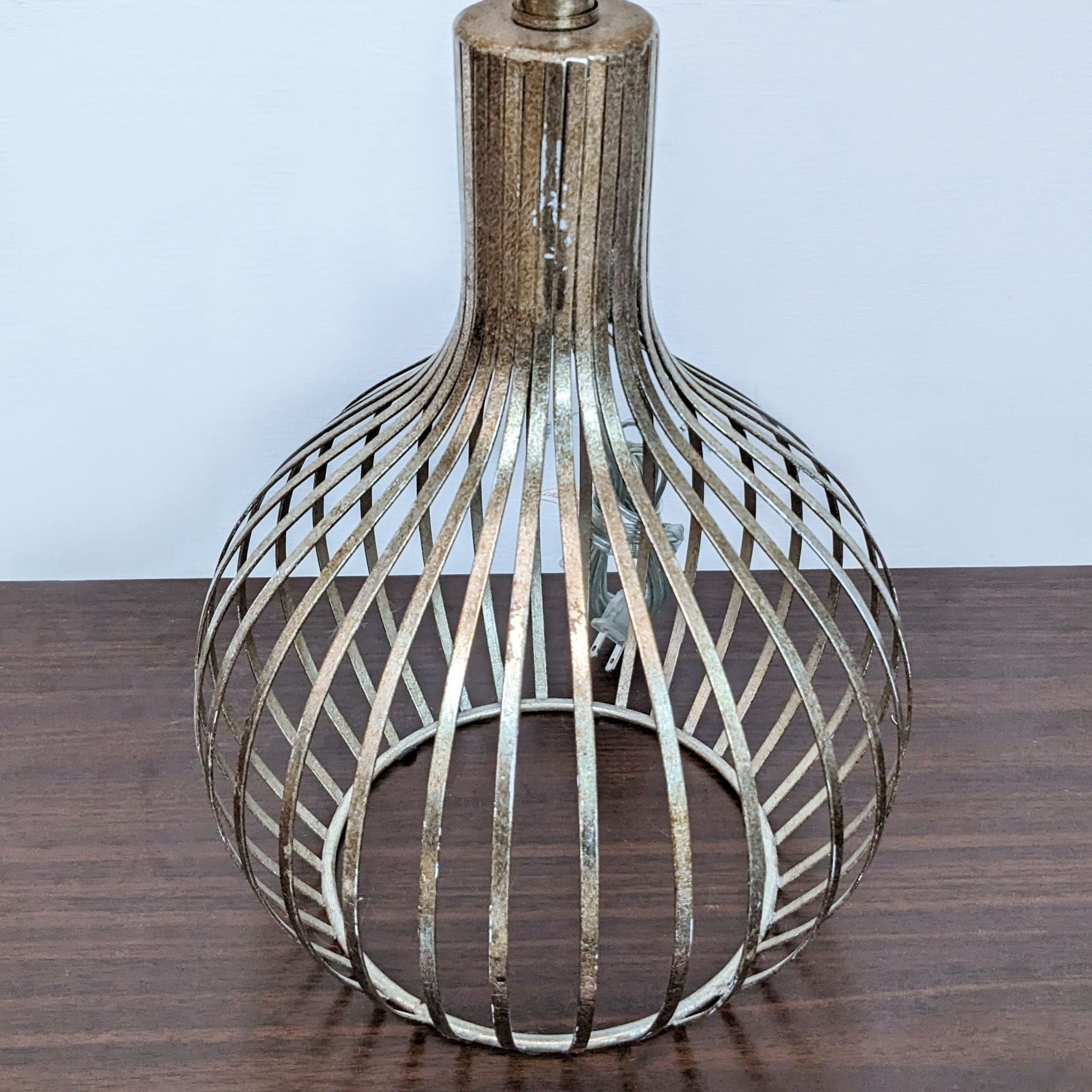Reperch brand vintage-style metallic pendant lamp with openwork design on wooden surface.