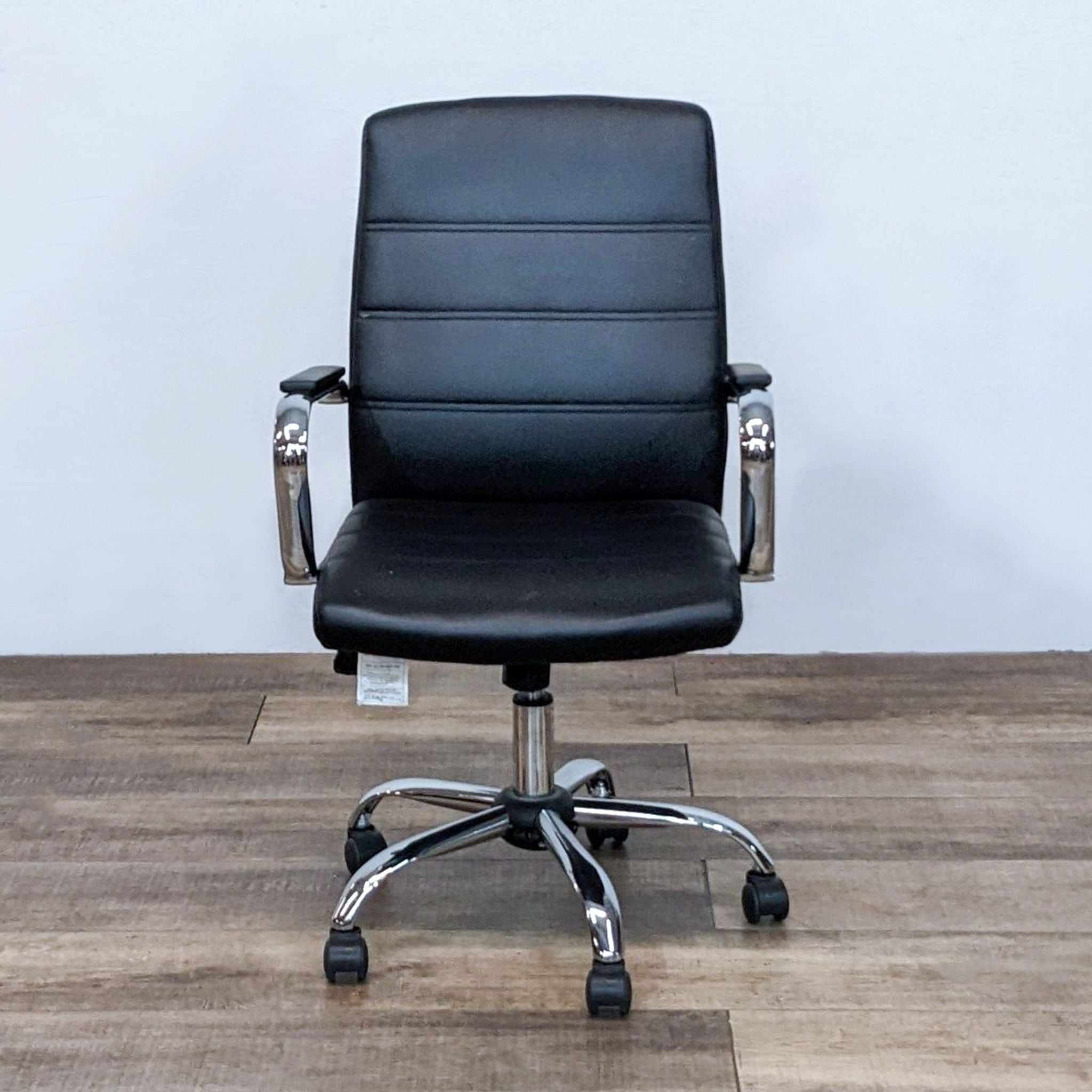 Alt text 1: Reperch branded mid-back office chair in black faux leather, with chrome arms and base, featuring tilt-lock and height adjustment.