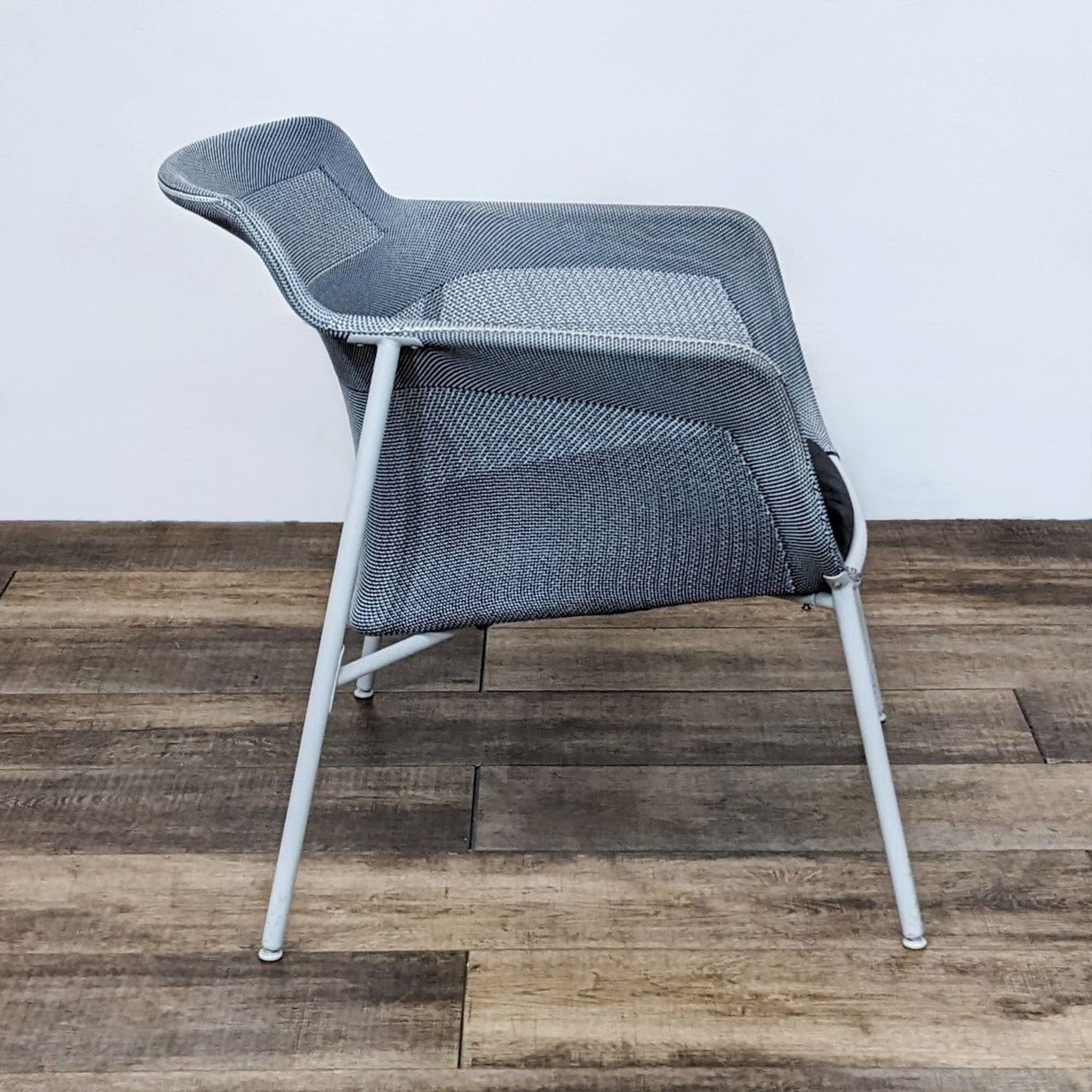 2. Side view of the IKEA PS 2017 lounge chair showcasing its ergonomic design with 3D-knitting technology and slim profile.