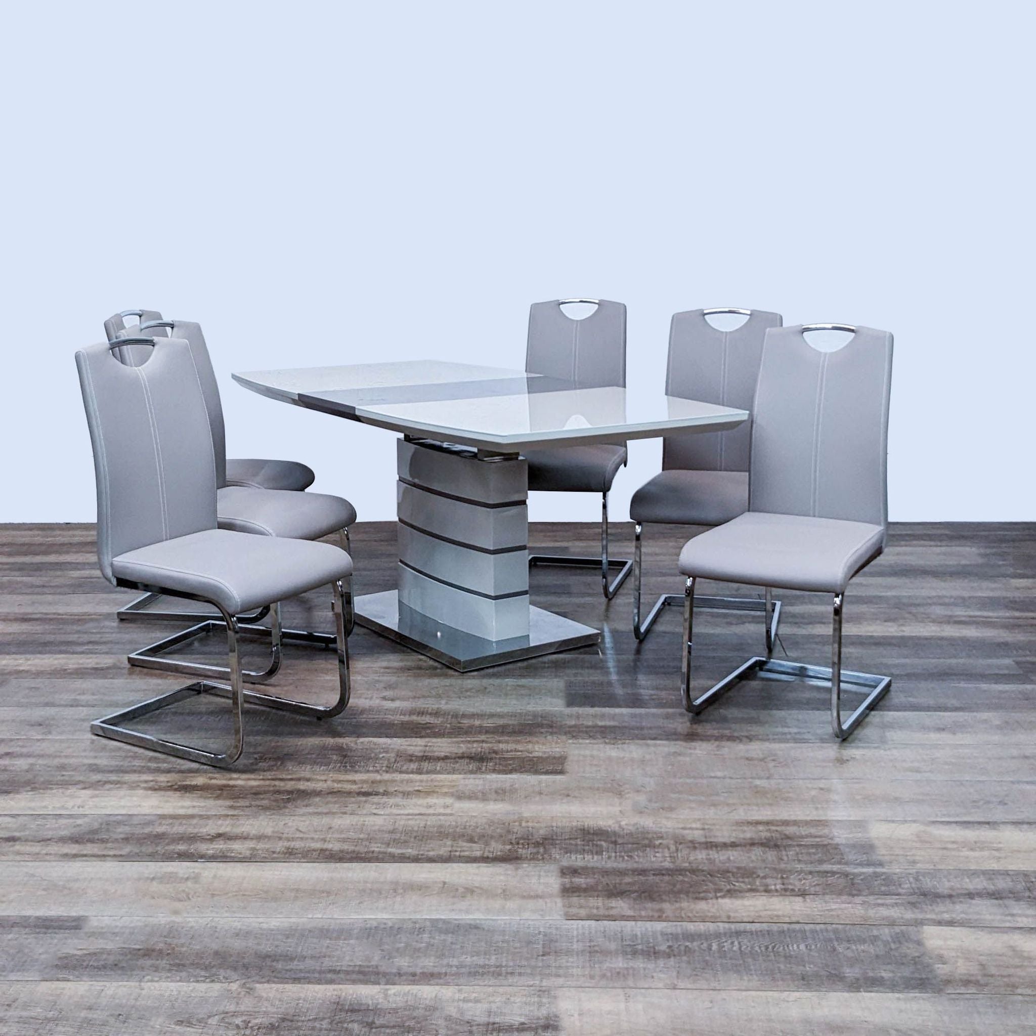 Alt text 1: A modern Reperch 7-piece dining set with high gloss white and gray-taupe table on a chrome base, accompanied by gray-taupe faux leather chairs.