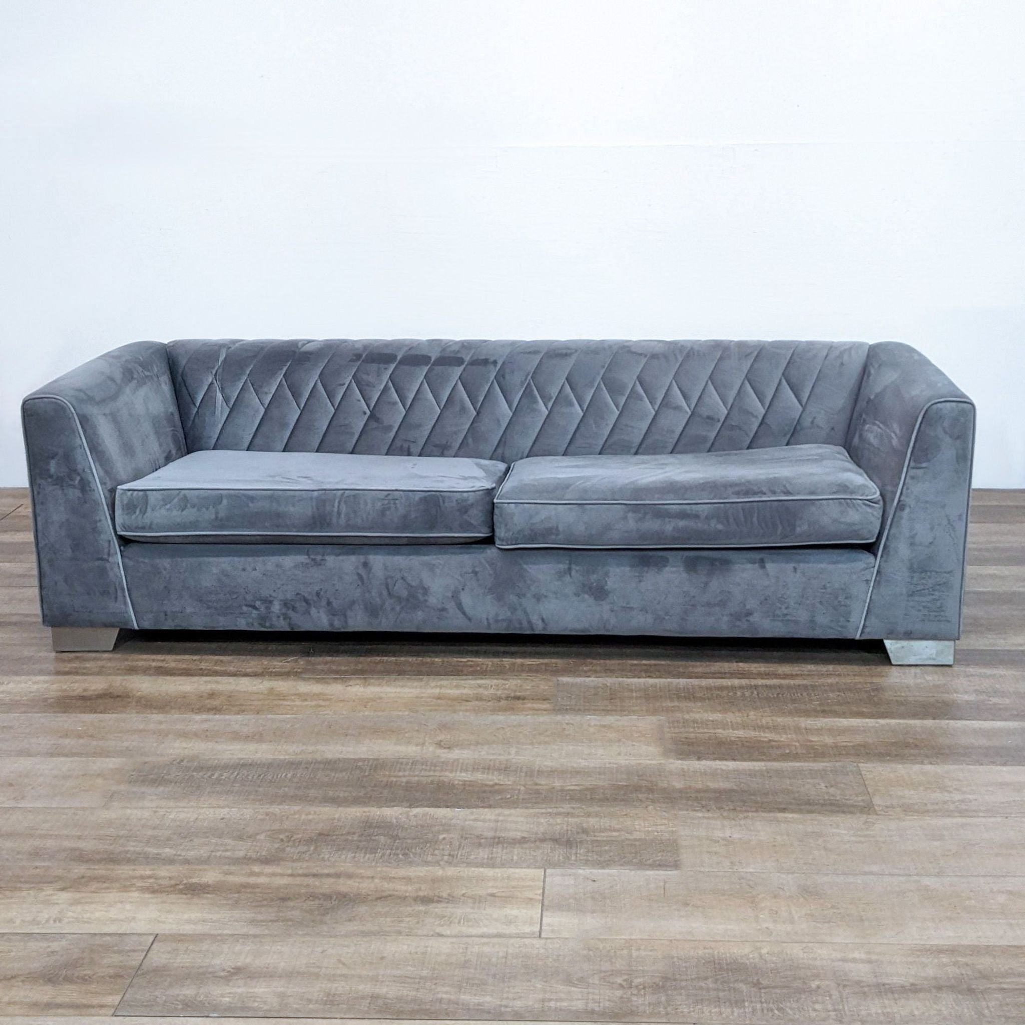 Alt text 1: Armen Living gray 3-seat sofa, tufted back, clean lines, with silver finish feet on a wood floor.