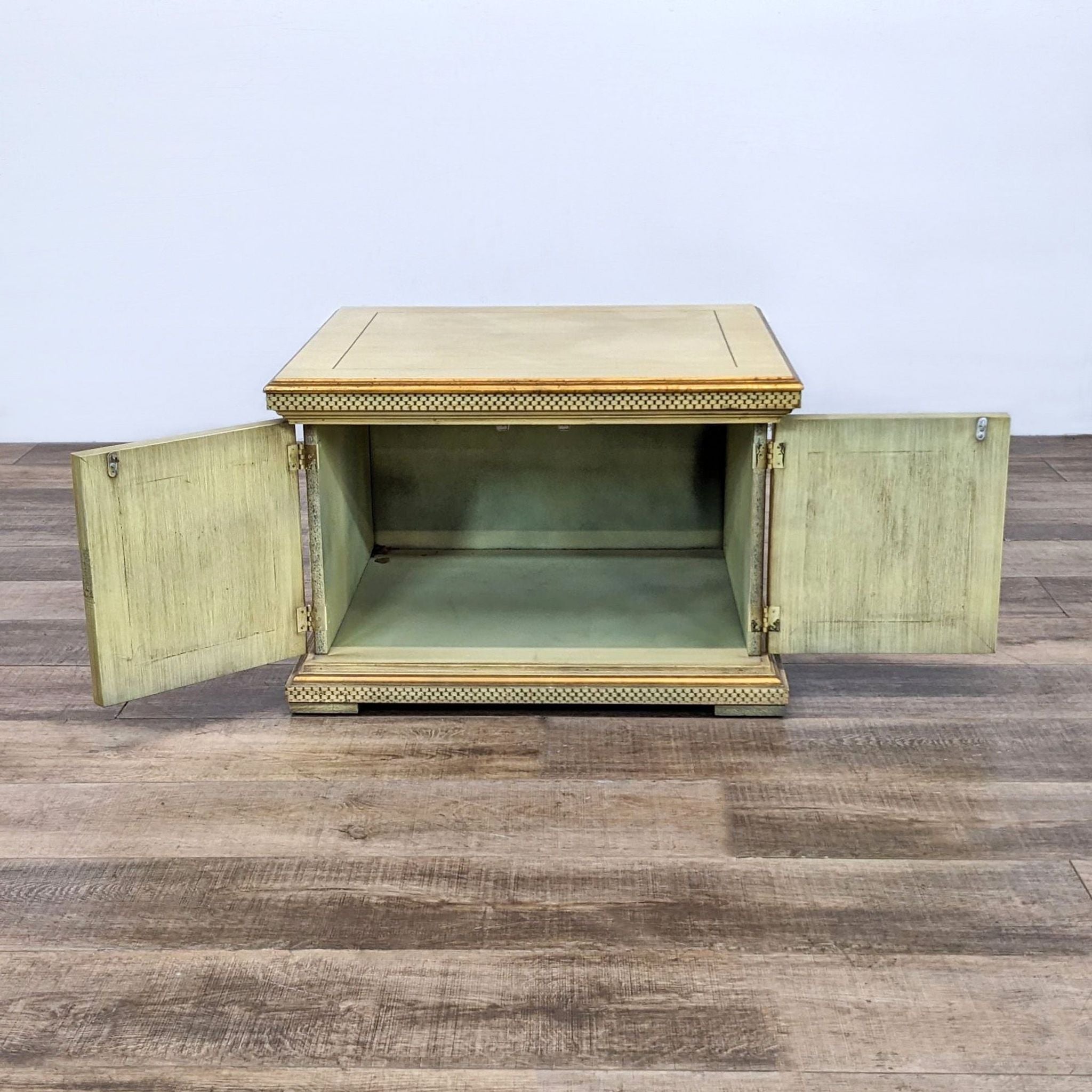 Reperch end table with open doors revealing interior shelf, showing traditional beaded design on wood flooring.