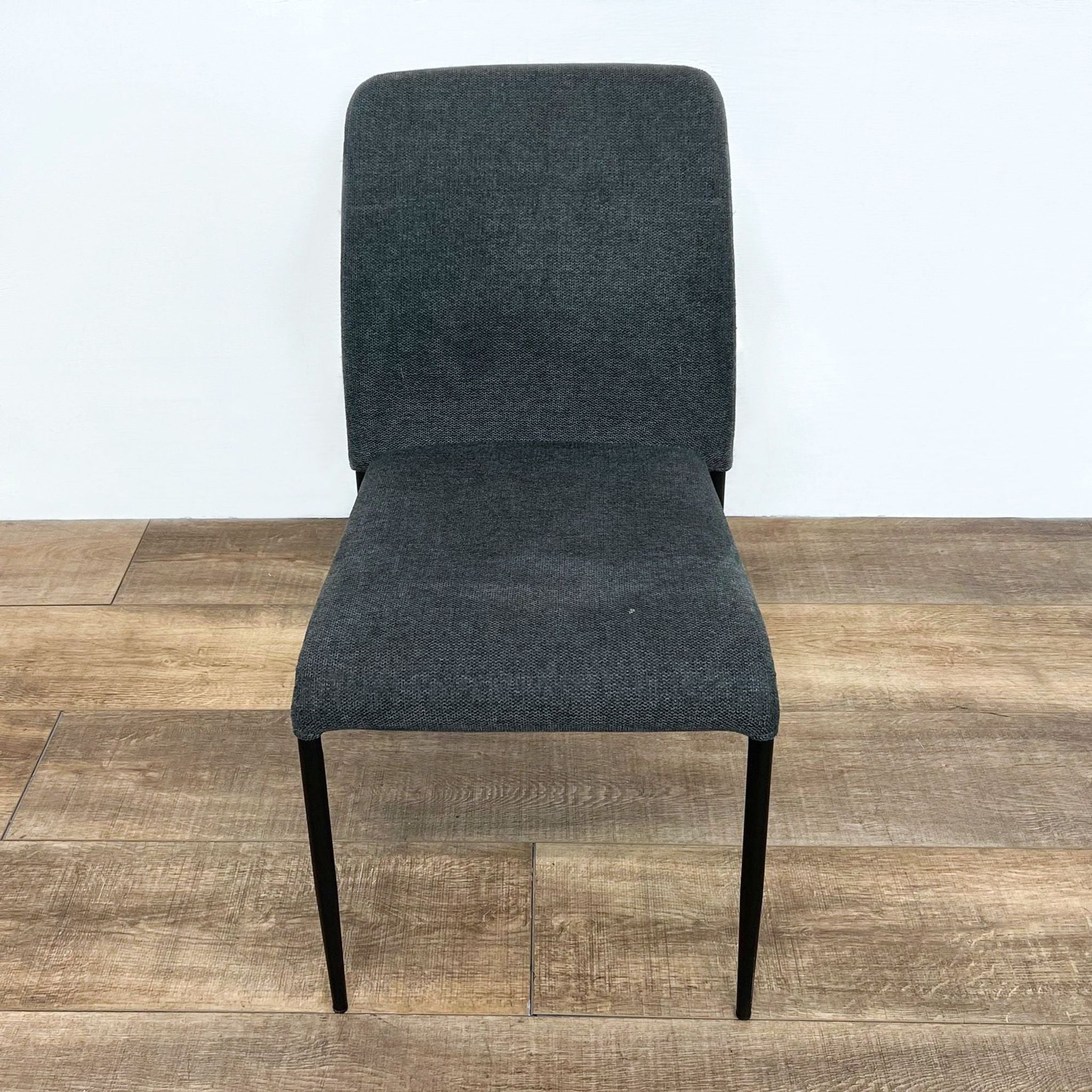 Reperch brand dining chair with dark upholstered seat and back on tapered legs, displayed on wooden floor.