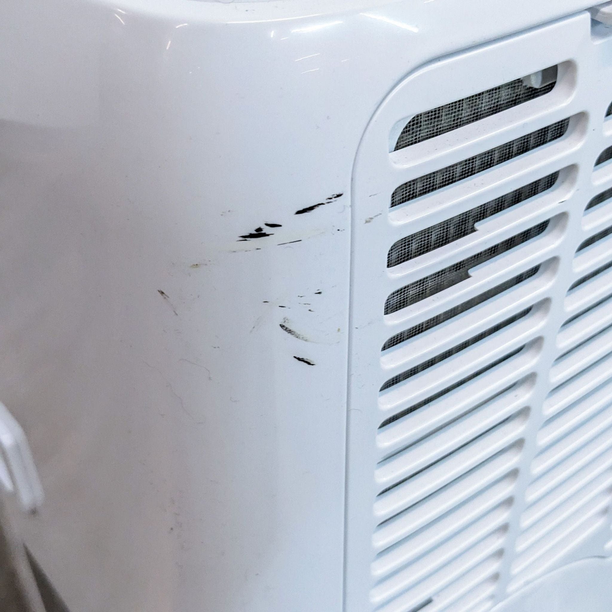 Image 3: Close-up of a Black + Decker AC unit showing wear and tear with visible scuff marks on its surface.