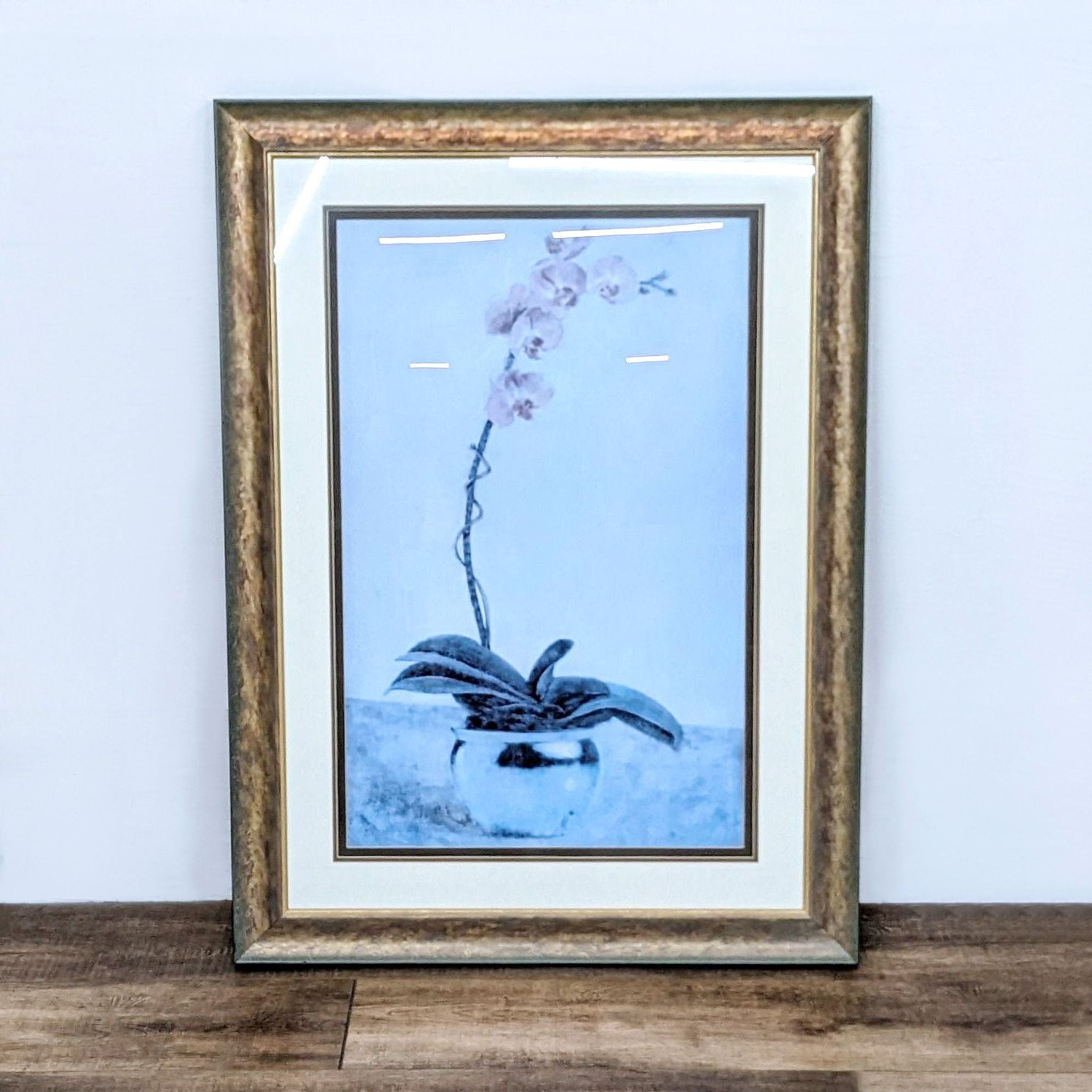 Reperch brand framed Giclee art print featuring an orchid in a planter on a wooden surface.