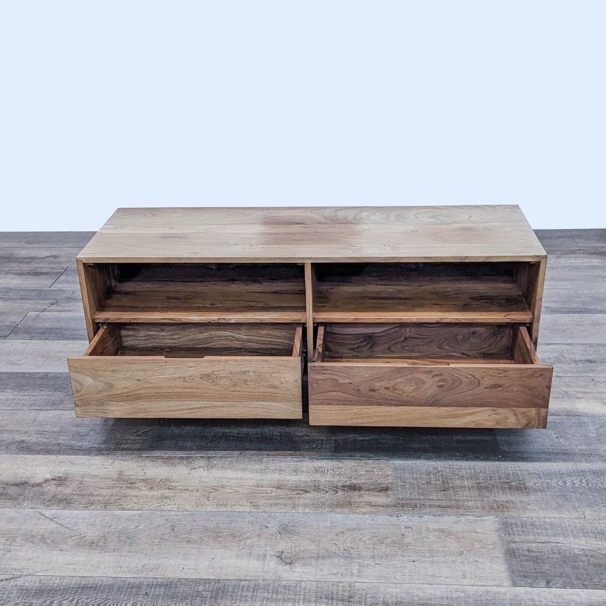 Wooden Reperch brand entertainment center with open compartments, featuring one drawer out, on a grey wood grain floor.