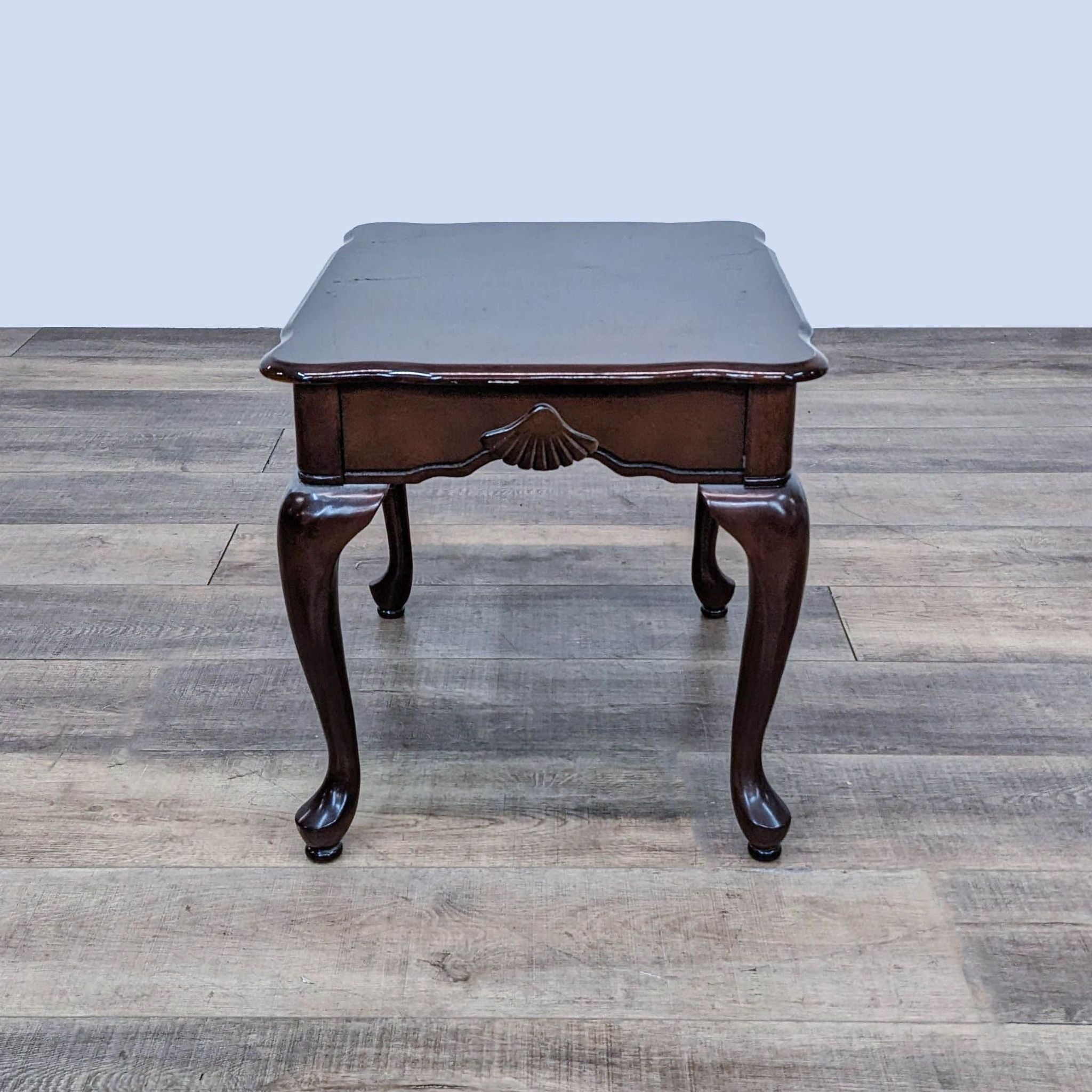 End table by Reperch featuring carved scallop shell embellishment and elegant curved legs.