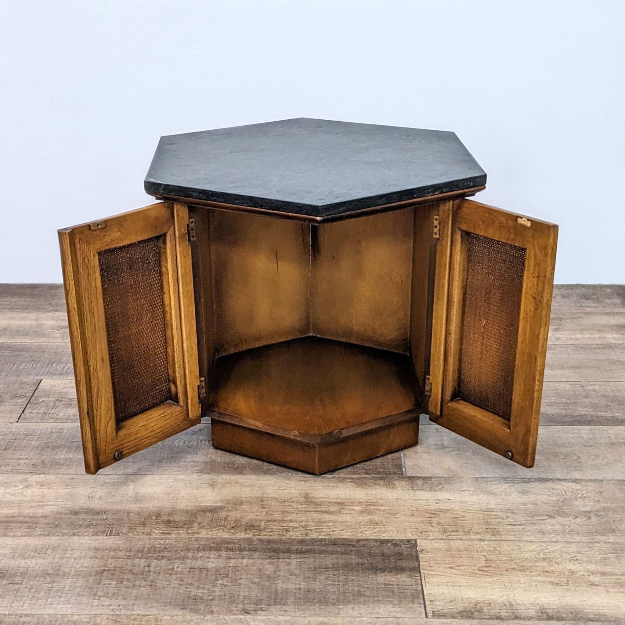 Reperch hexagonal end table showing open rattan doors with interior storage space.