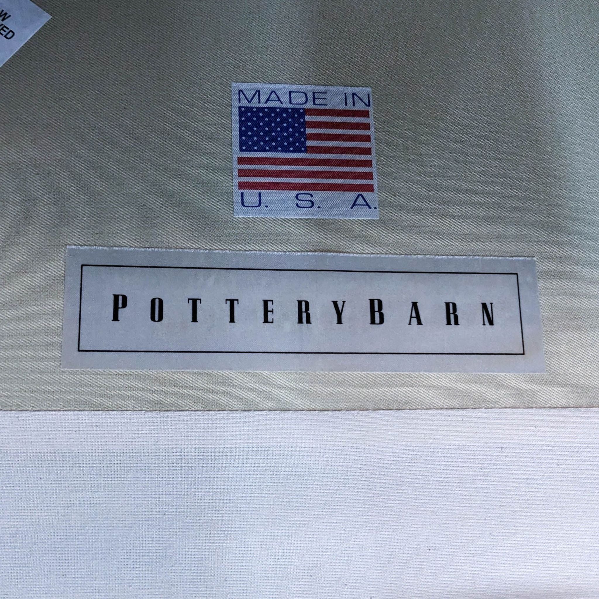 Close-up of a Pottery Barn label on a gray fabric, indicating it is made in the U.S.A.