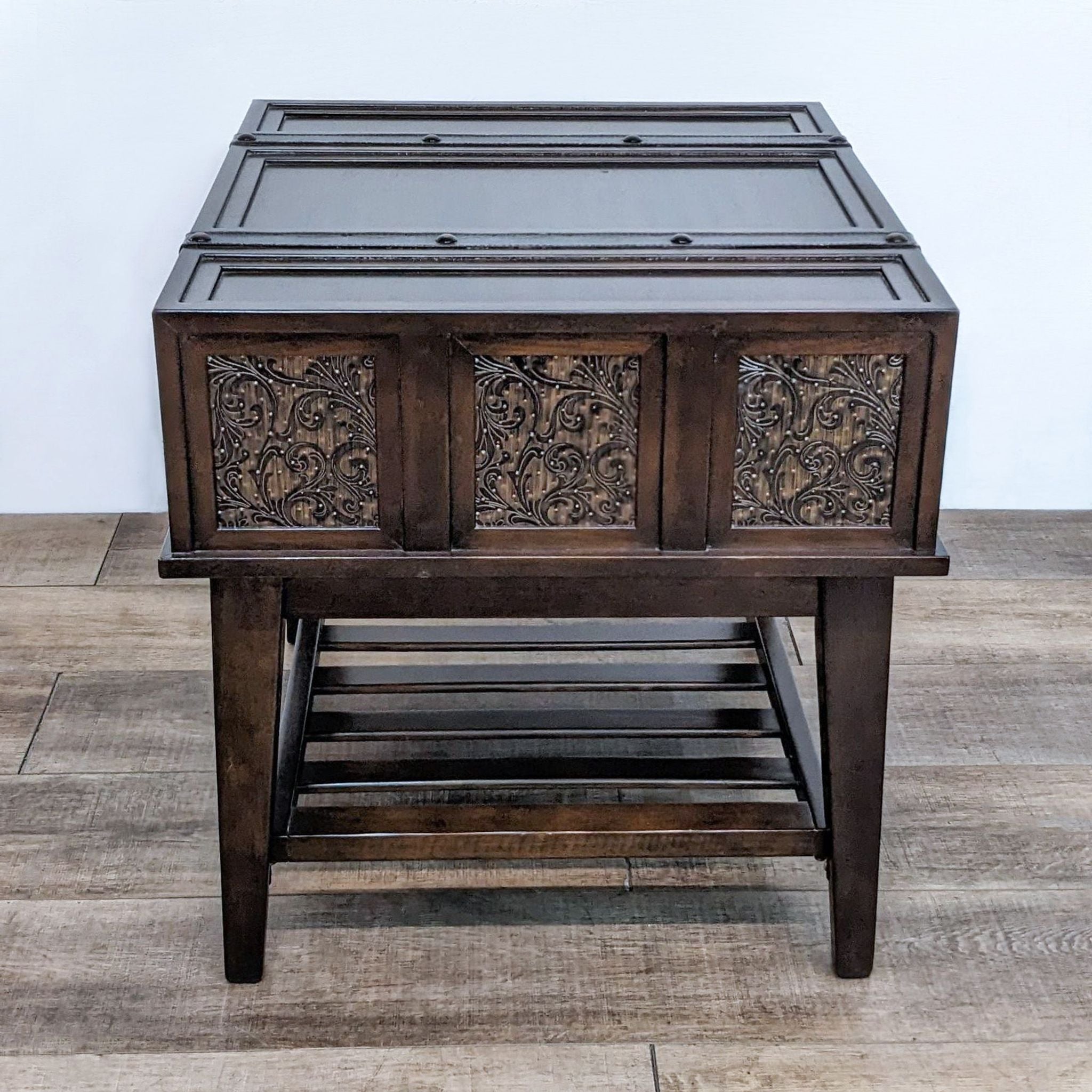 Reperch brand end table with decorative drawer fronts, leather straps, and slatted lower shelf on a wooden floor.
