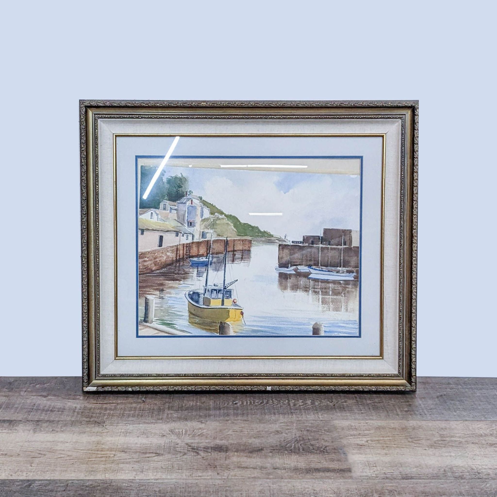Watercolor print of a yellow sailboat in a canal, matted and framed, by Reperch from Fisher Galleries.