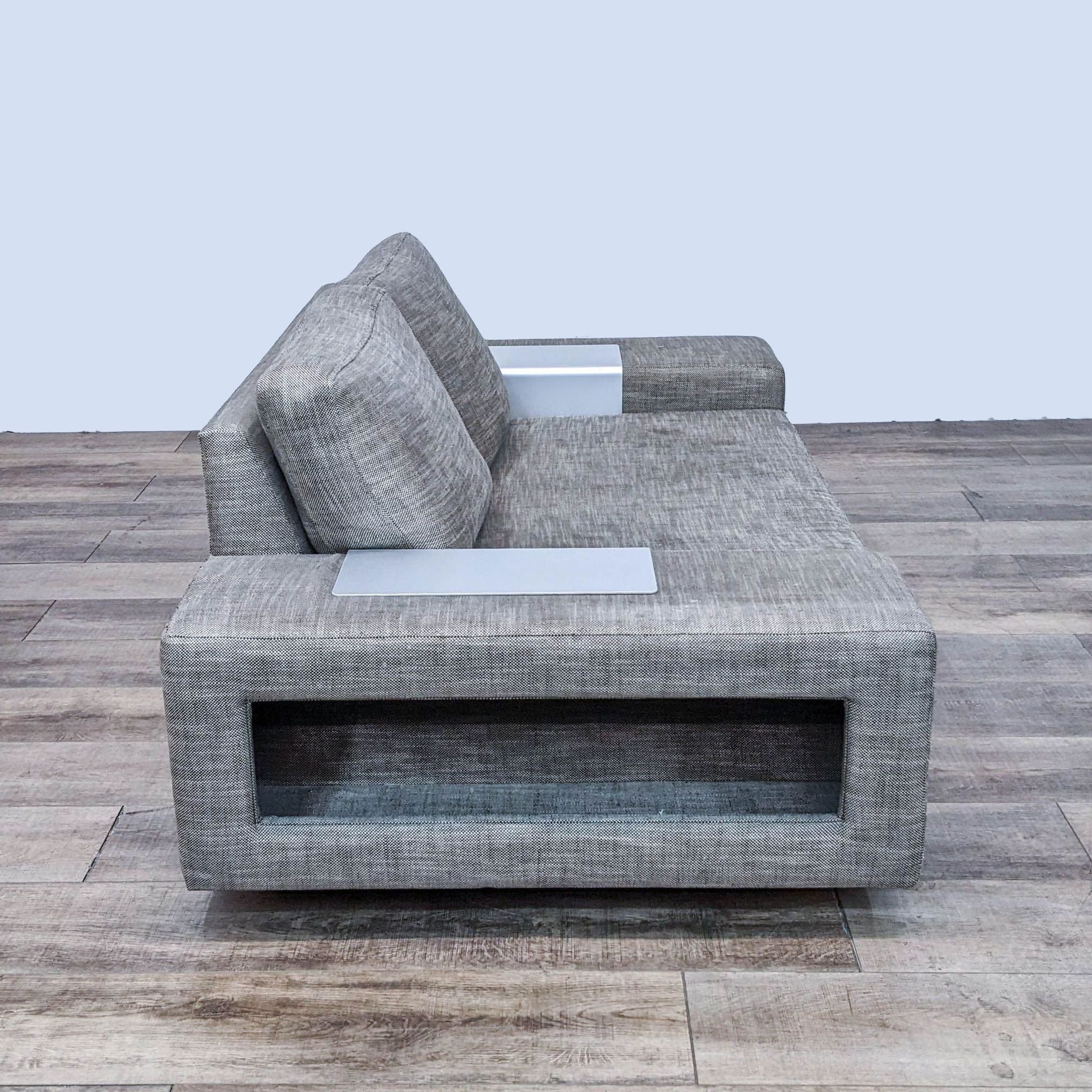 Modern 3-seat compact block arm sofa by Viesso Furniture with gray upholstery and inset side detailing on wooden floor.