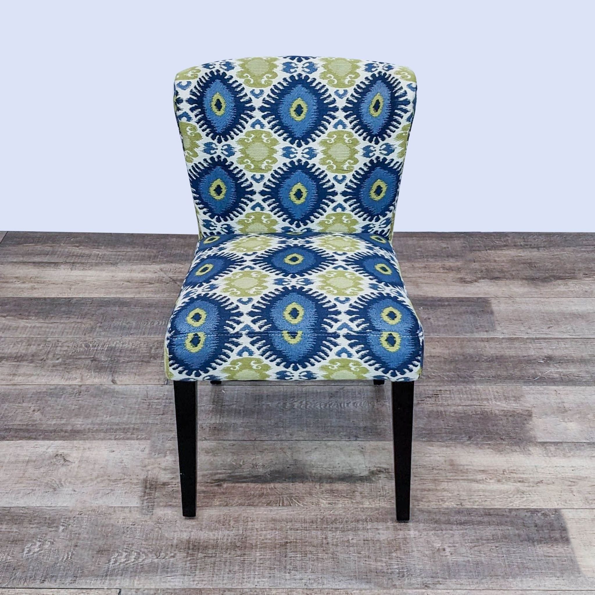 Cost Plus transitional dining chair with Ikat fabric and tapered legs, viewed frontally.