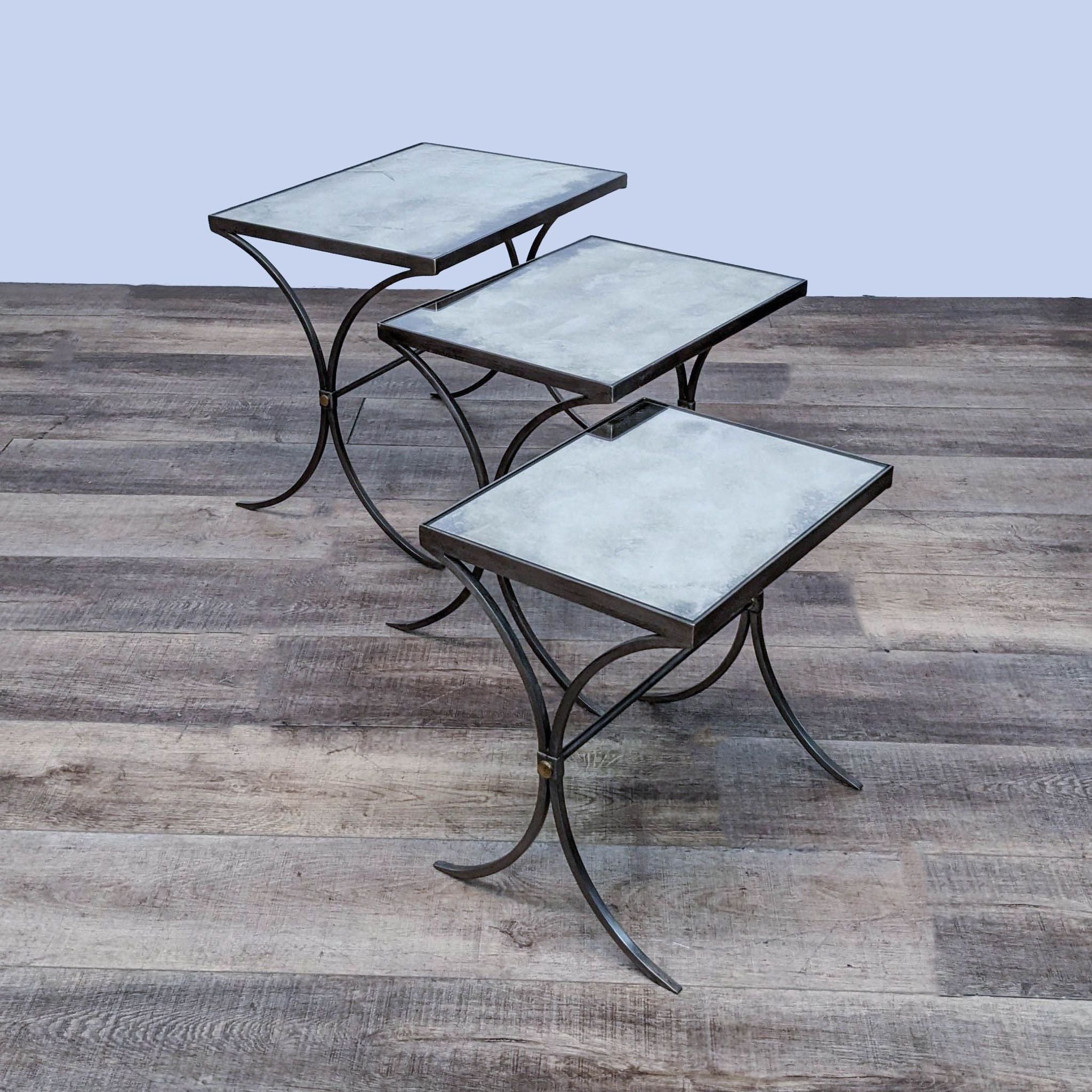 Set of three nesting end tables by Bernhardt Furniture, each with curved metal legs and mirrored tops.