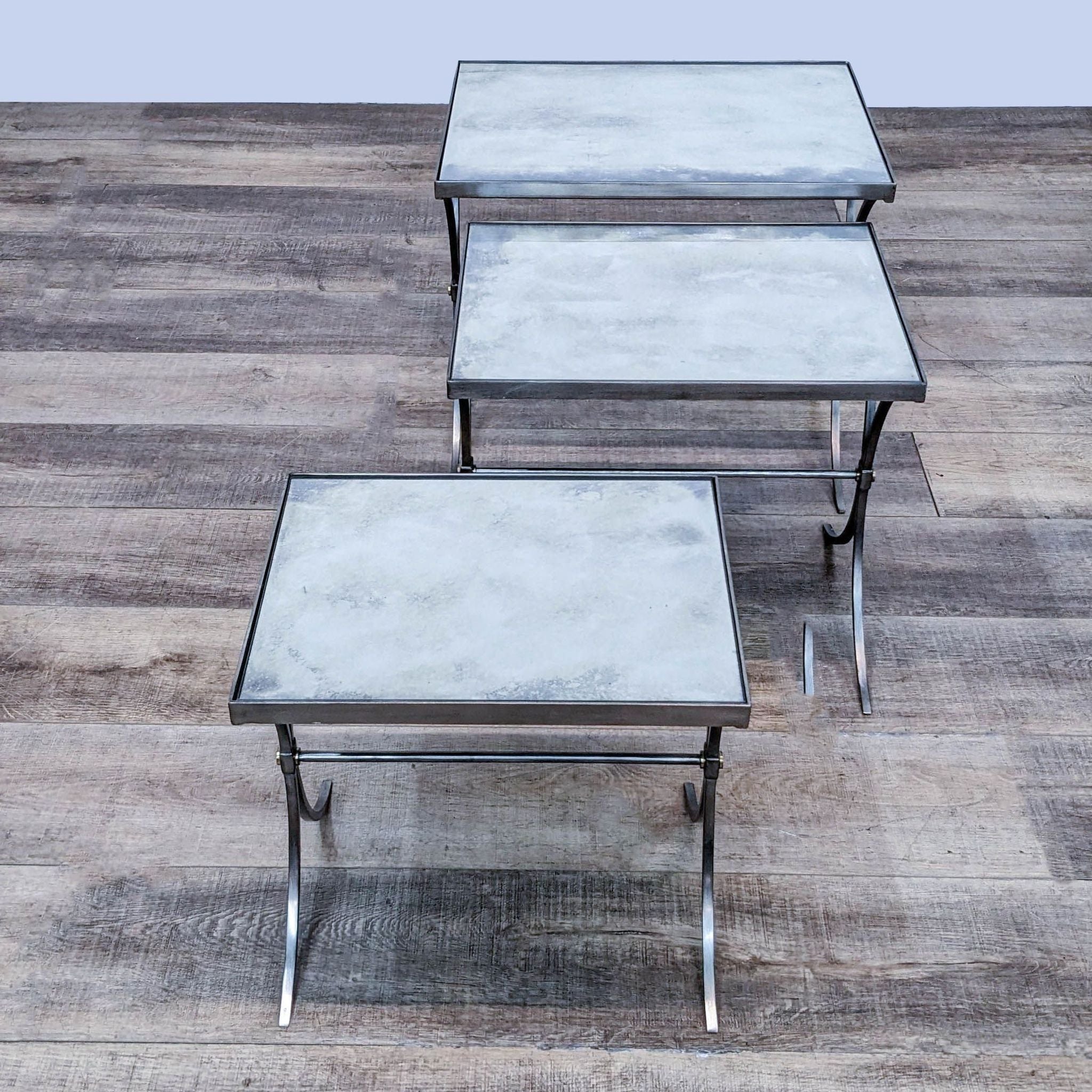 Three Bernhardt Furniture metal end tables with mirrored tops on a wooden floor.