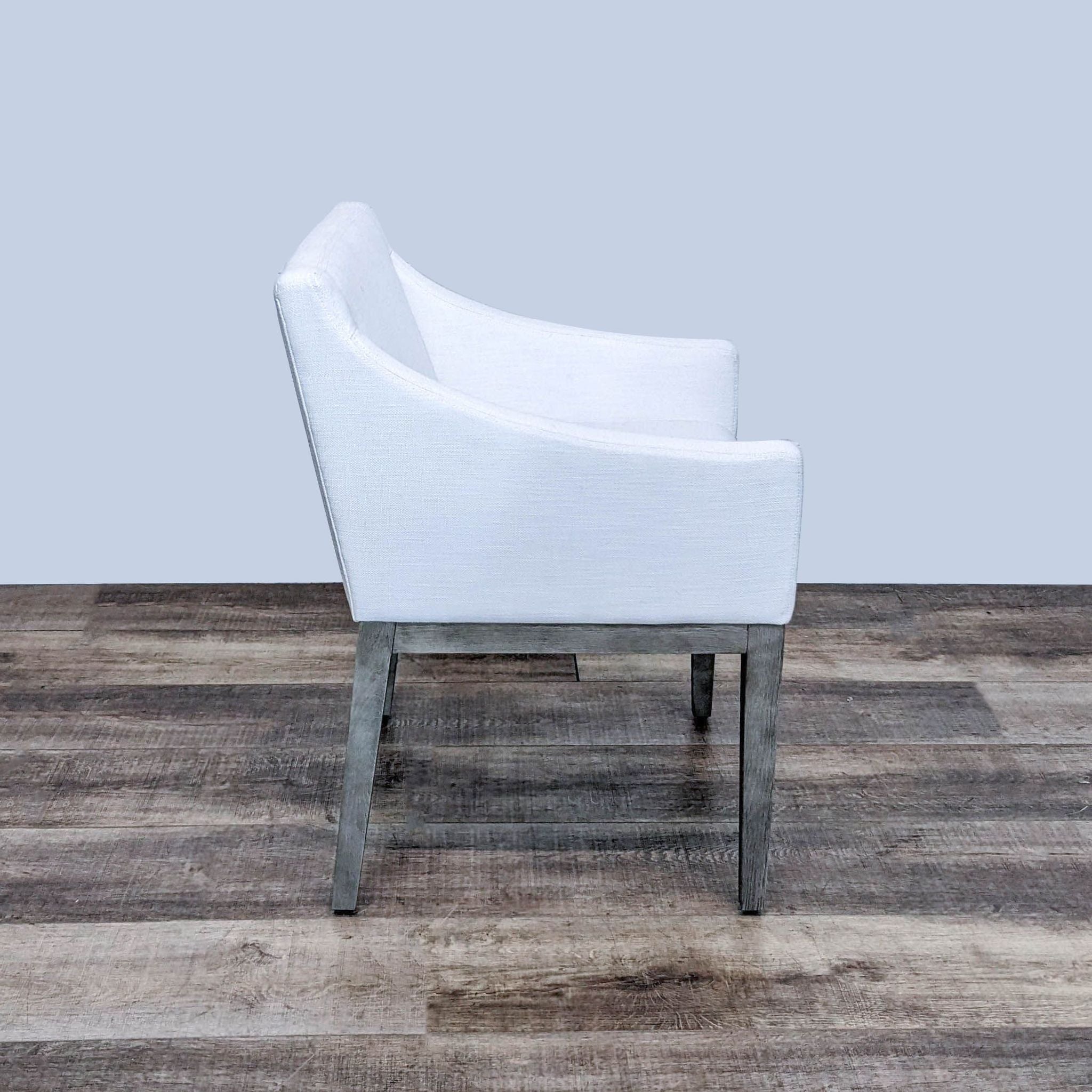 Angular Morgan lounge chair by Restoration Hardware with tapered wooden legs, plush upholstery, and foam cushioning.