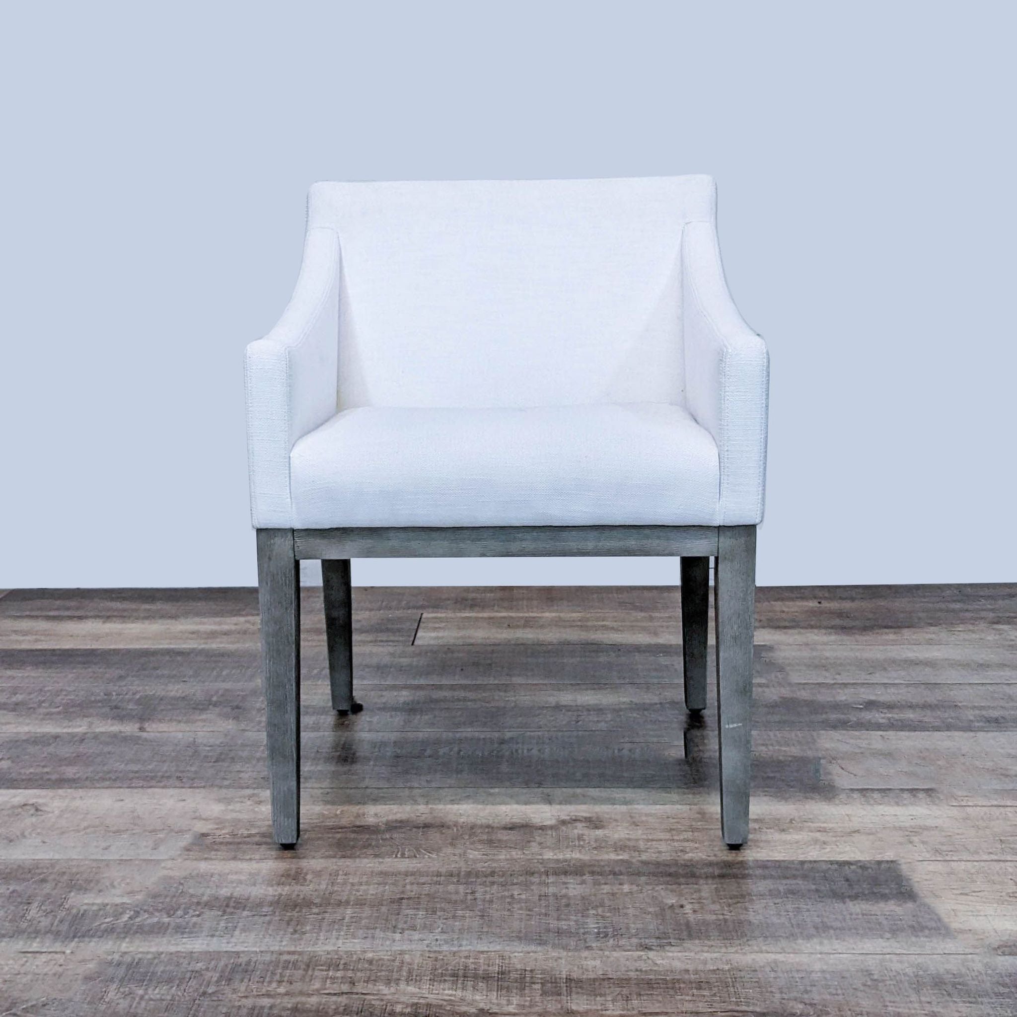 Restoration Hardware Morgan dining chair with midcentury design, angular silhouette, wooden frame, and white upholstery.