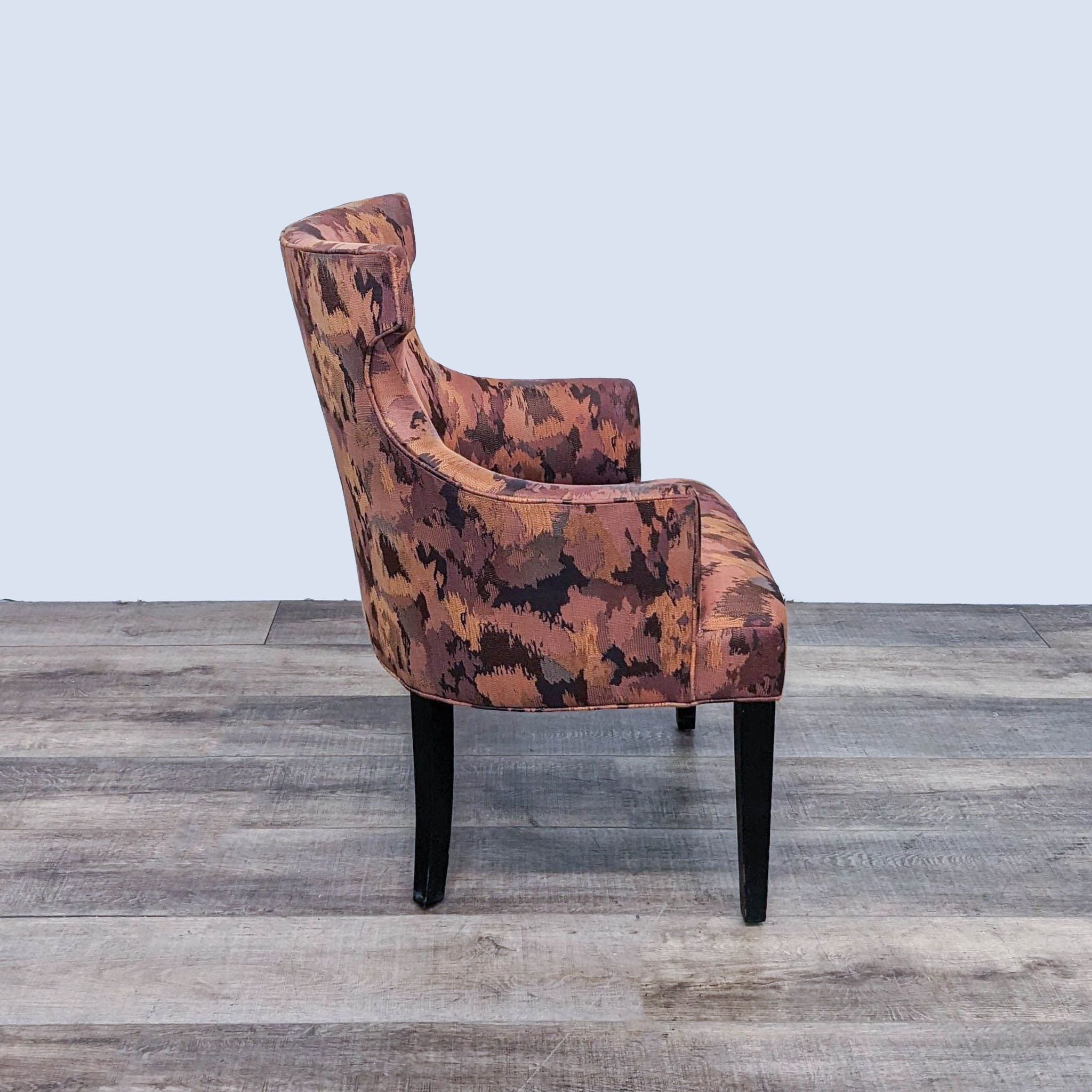 Reperch Alinea contemporary wingback chair with camouflage-like design, angled view on wood flooring.