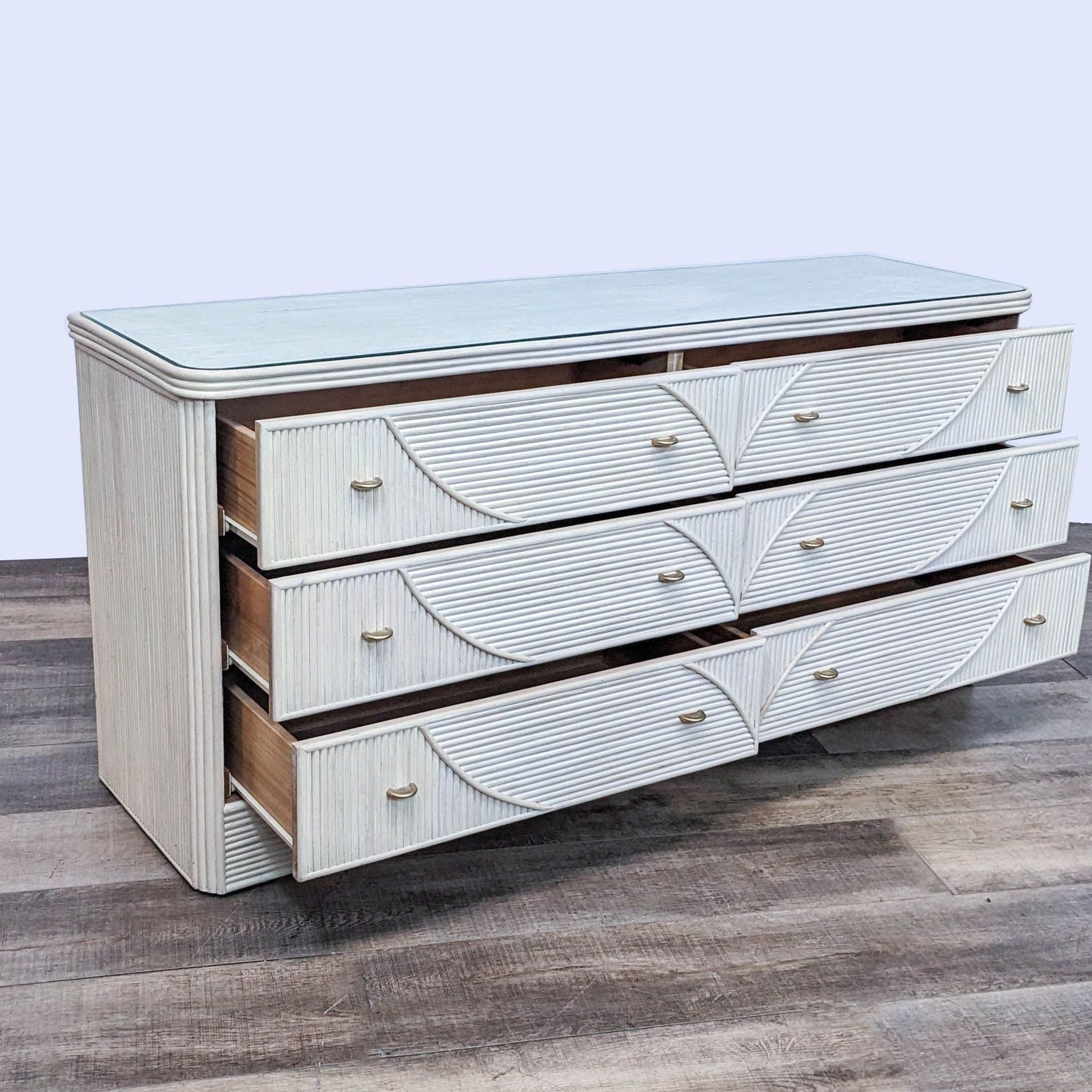 Late 20th-century 6-drawer pencil reed dresser with a coastal design and a protective glass cover.