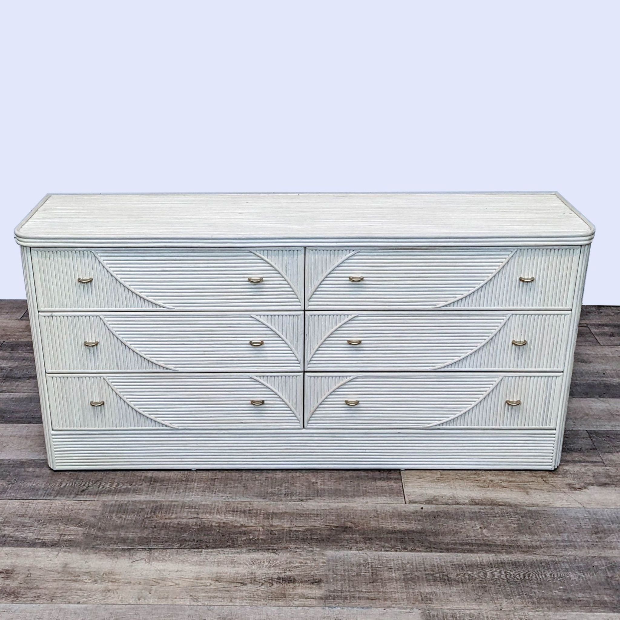 Alt text: Late 20th-century vintage Coastal Furniture brand dresser with cerused finish, six reed-style drawers, and a protective glass top on a wooden floor.