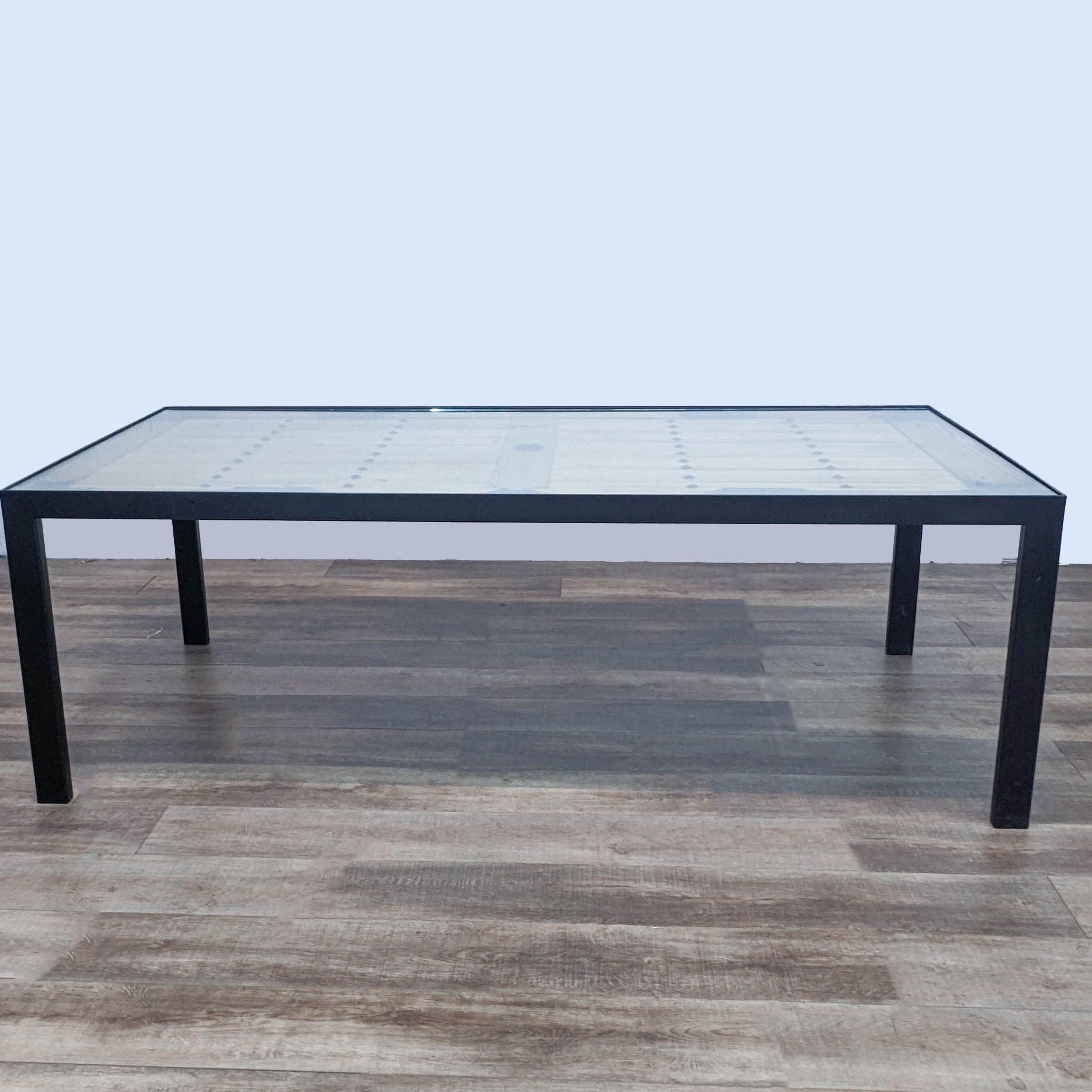 Alt text 2: Modern glass-top dining table from Tansu Design featuring a repurposed Japanese warehouse door base.