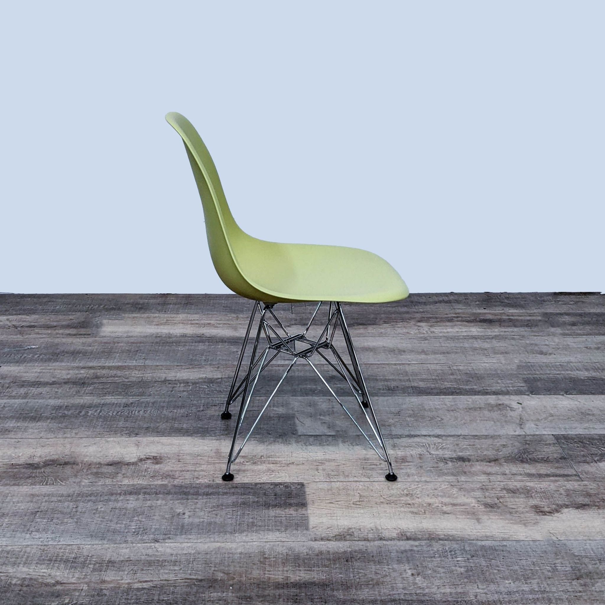 Alt text 2: Side view of a Vitra Eames chair with flexible back and waterfall edge, set against a plain background.