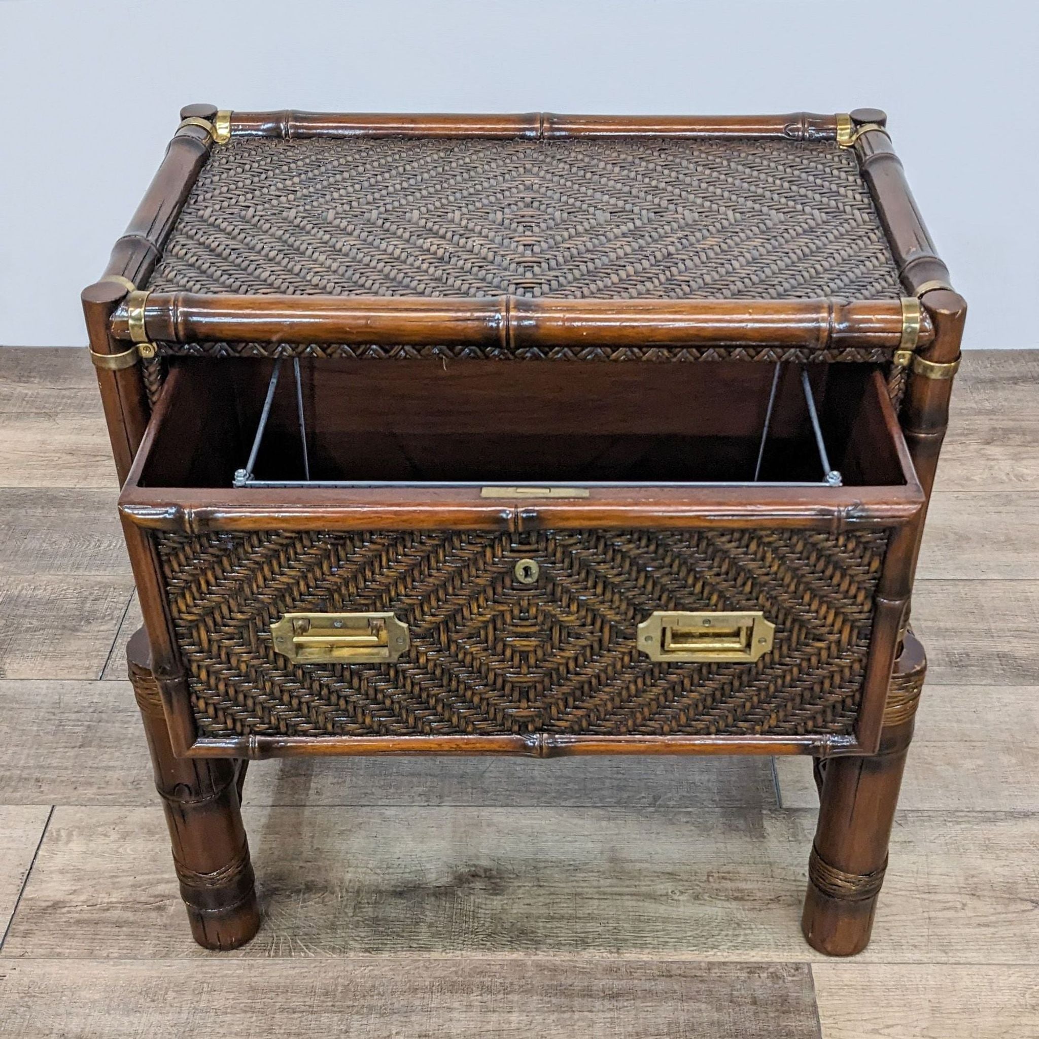 Reperch bamboo end table showing open drawer with brass accents and herringbone pattern, viewed from above.