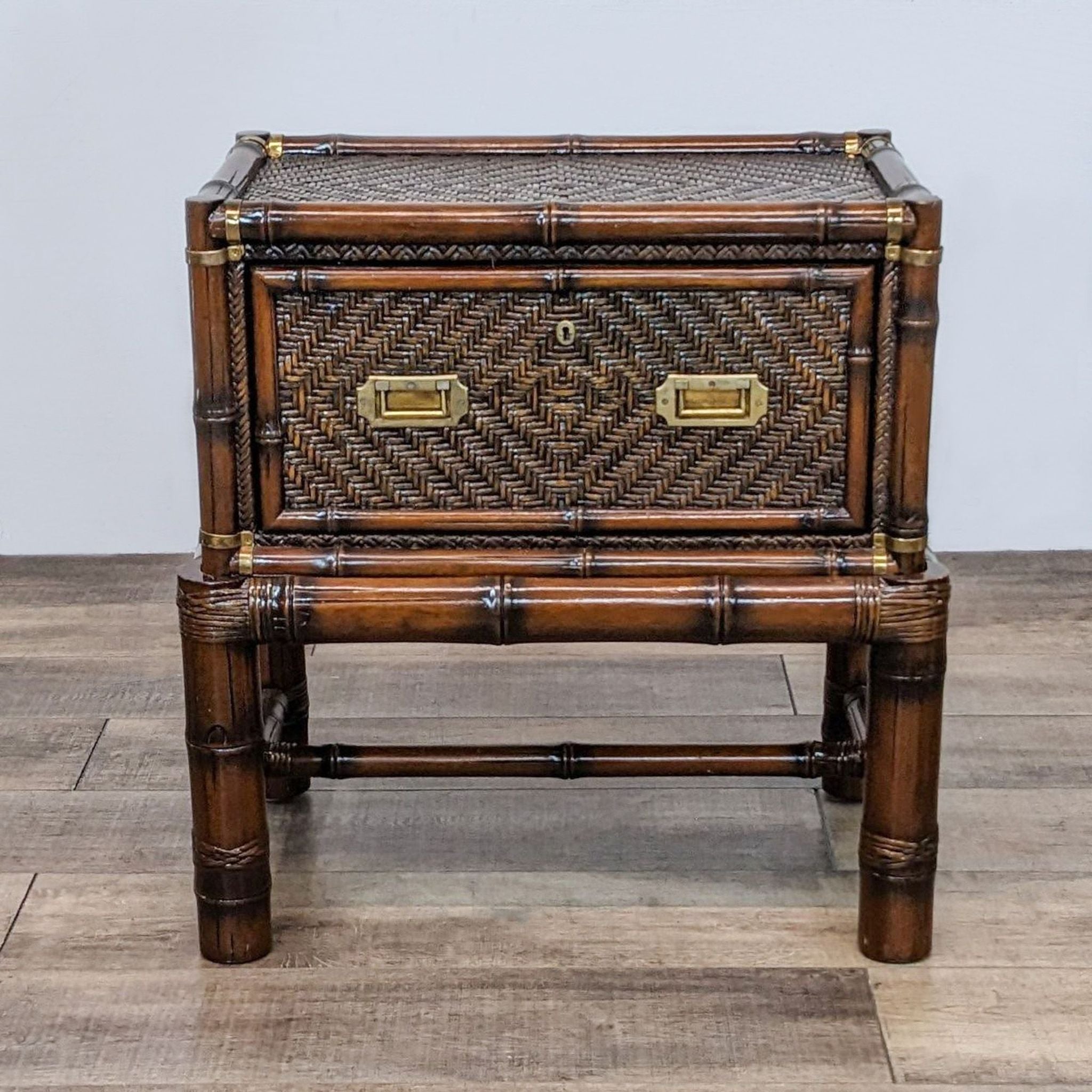 Reperch bamboo end table with brass accents and herringbone weave on closed drawer, seen from the front.