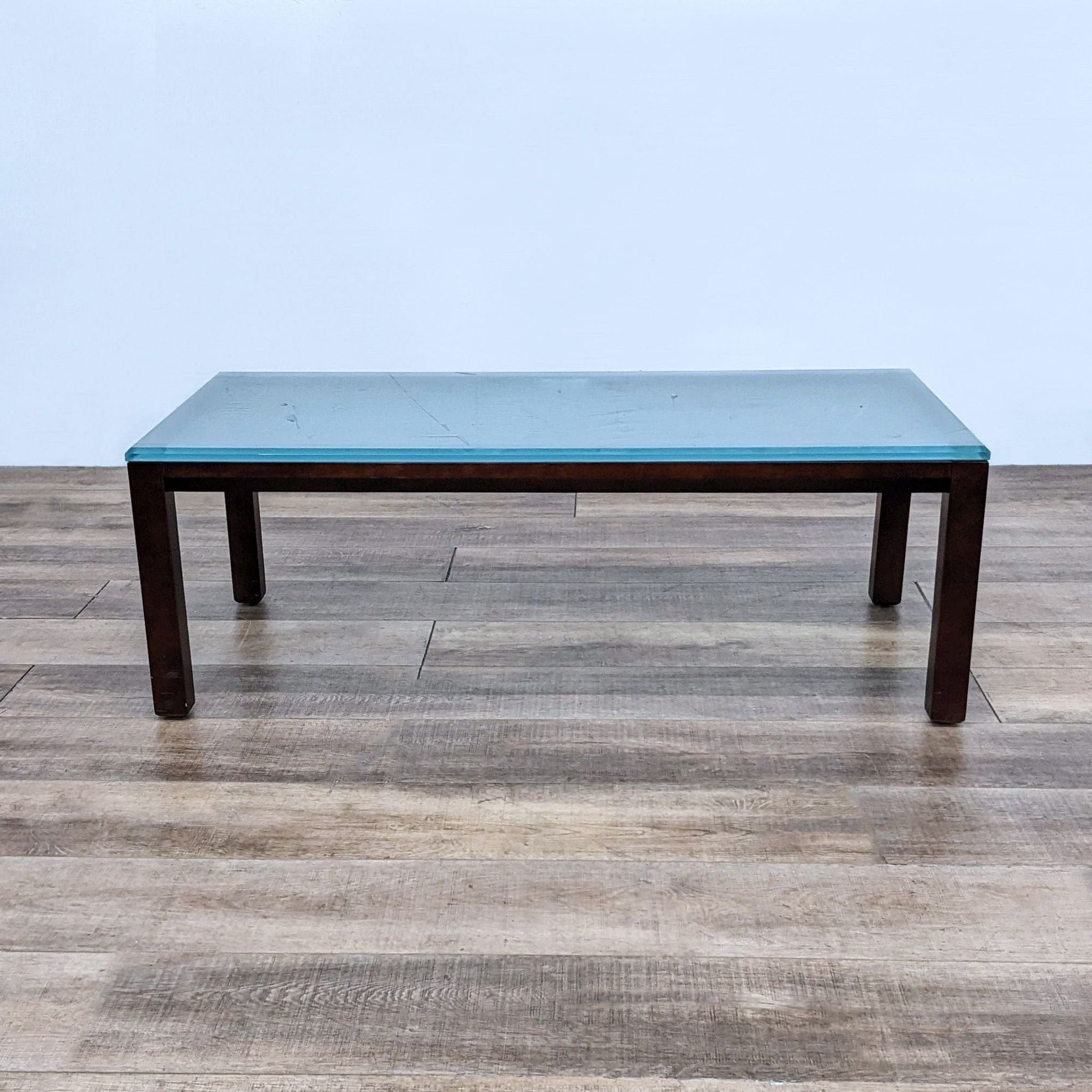 Reperch brand coffee table with a dark wood base and a frosted glass top, viewed from the front.