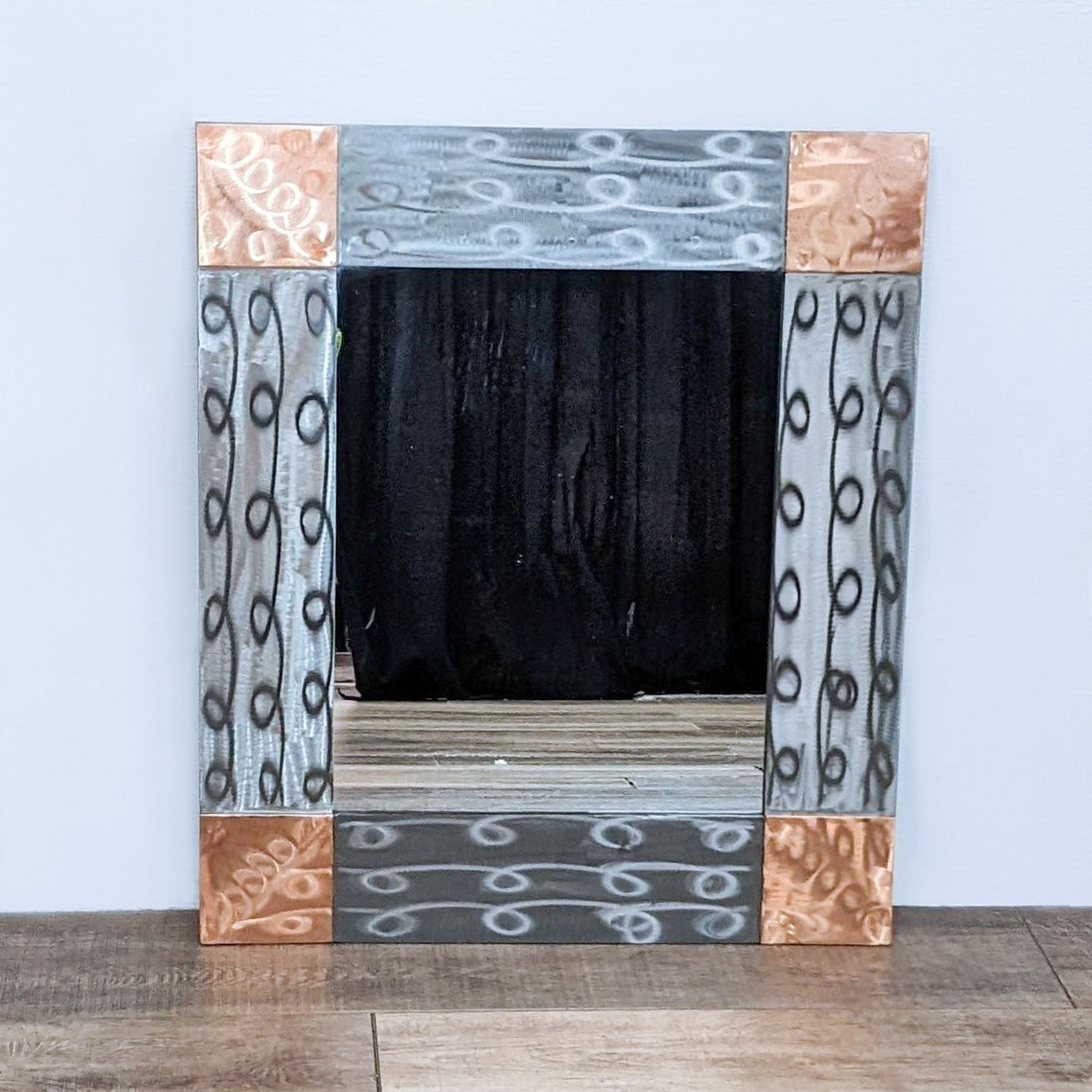 Metallic Reperch mirror featuring reflective wave-design panels, perfect for versatile decor styles.