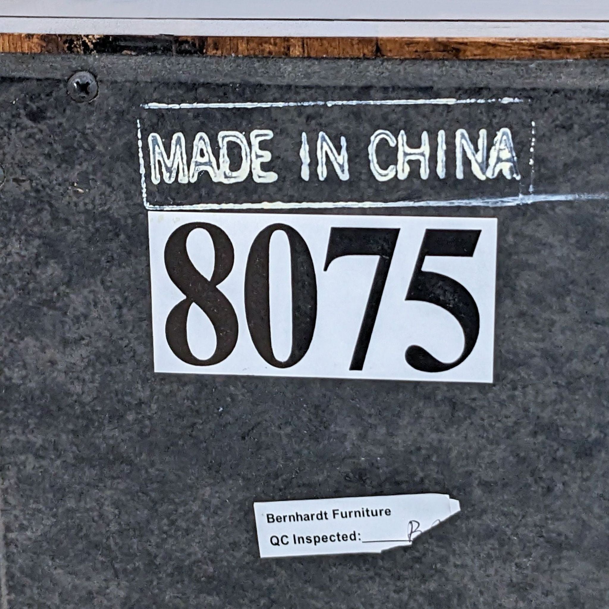 Label on a Bernhardt Furniture mirror indicating "Made in China" and quality control approval with a number 8075.
