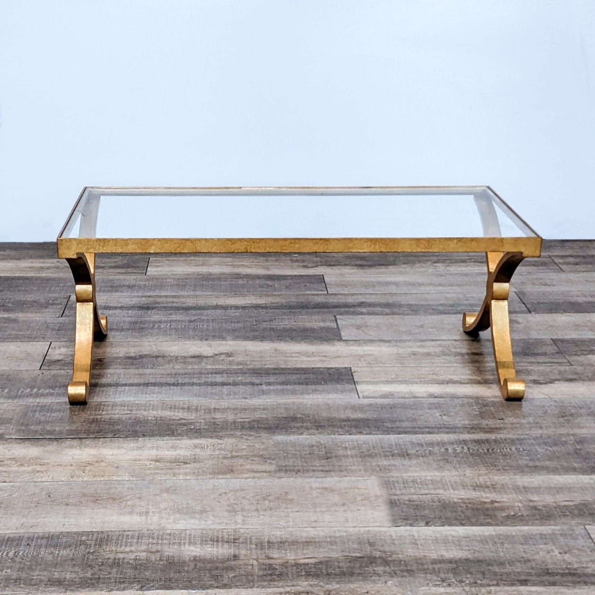 David Iatesta designer coffee table featuring a glass top and a structured gilt metal base, adding sophistication to any space.