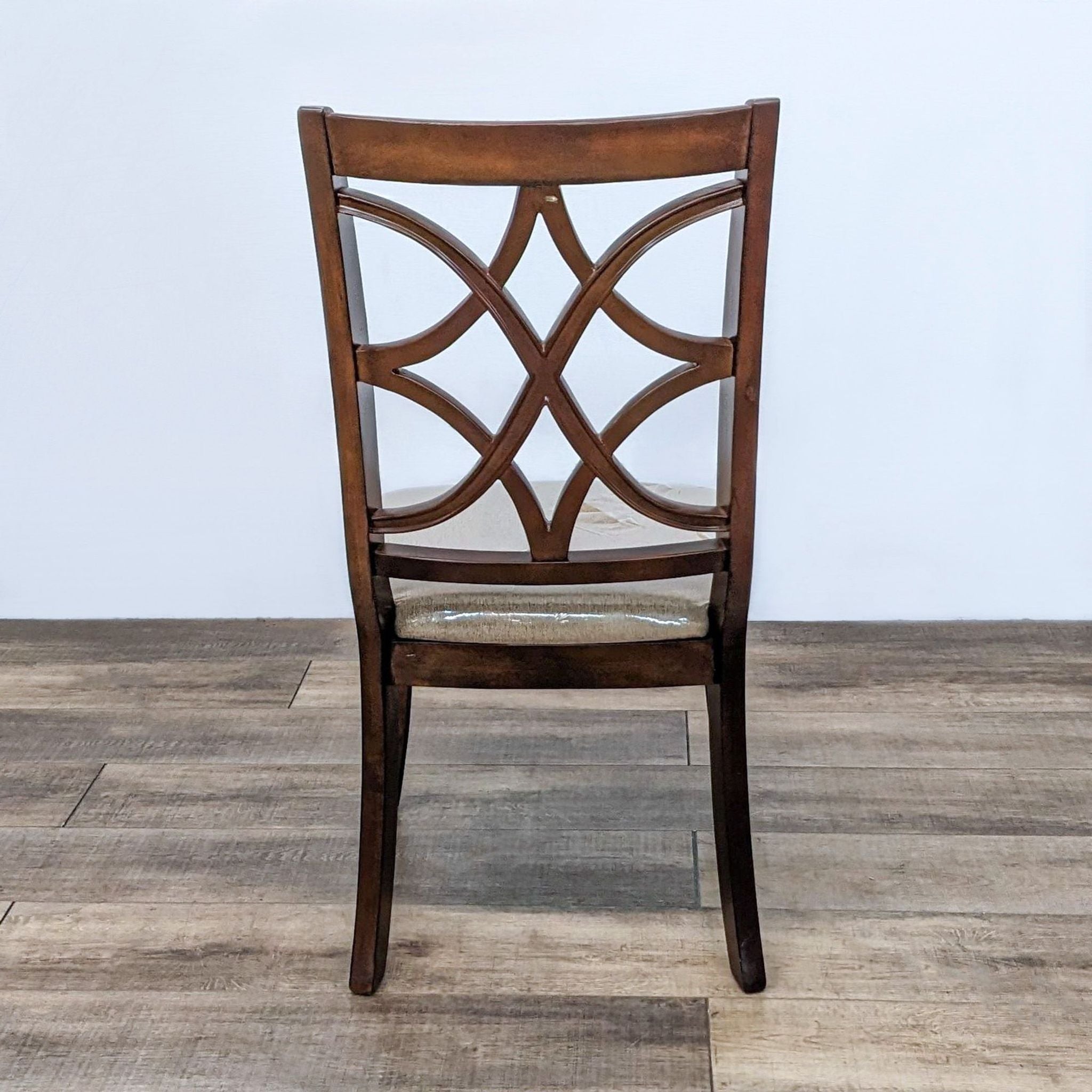 Reperch brand contemporary dining chair with lattice back and beige upholstered seat on a wooden floor.