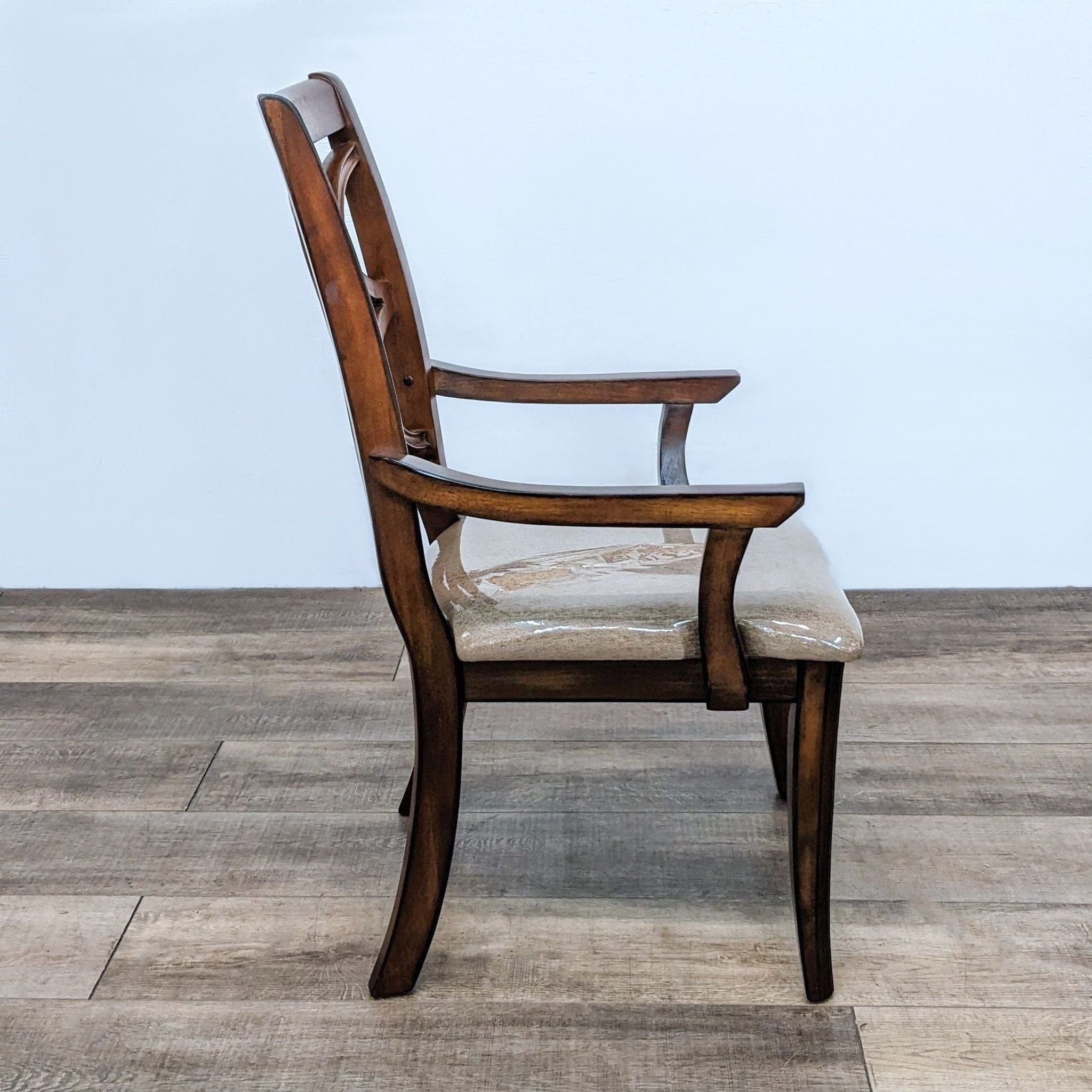 Alt text 2: Side view of a Macy’s contemporary dining chair with lattice back design and a cushioned seat in a room with wood flooring.