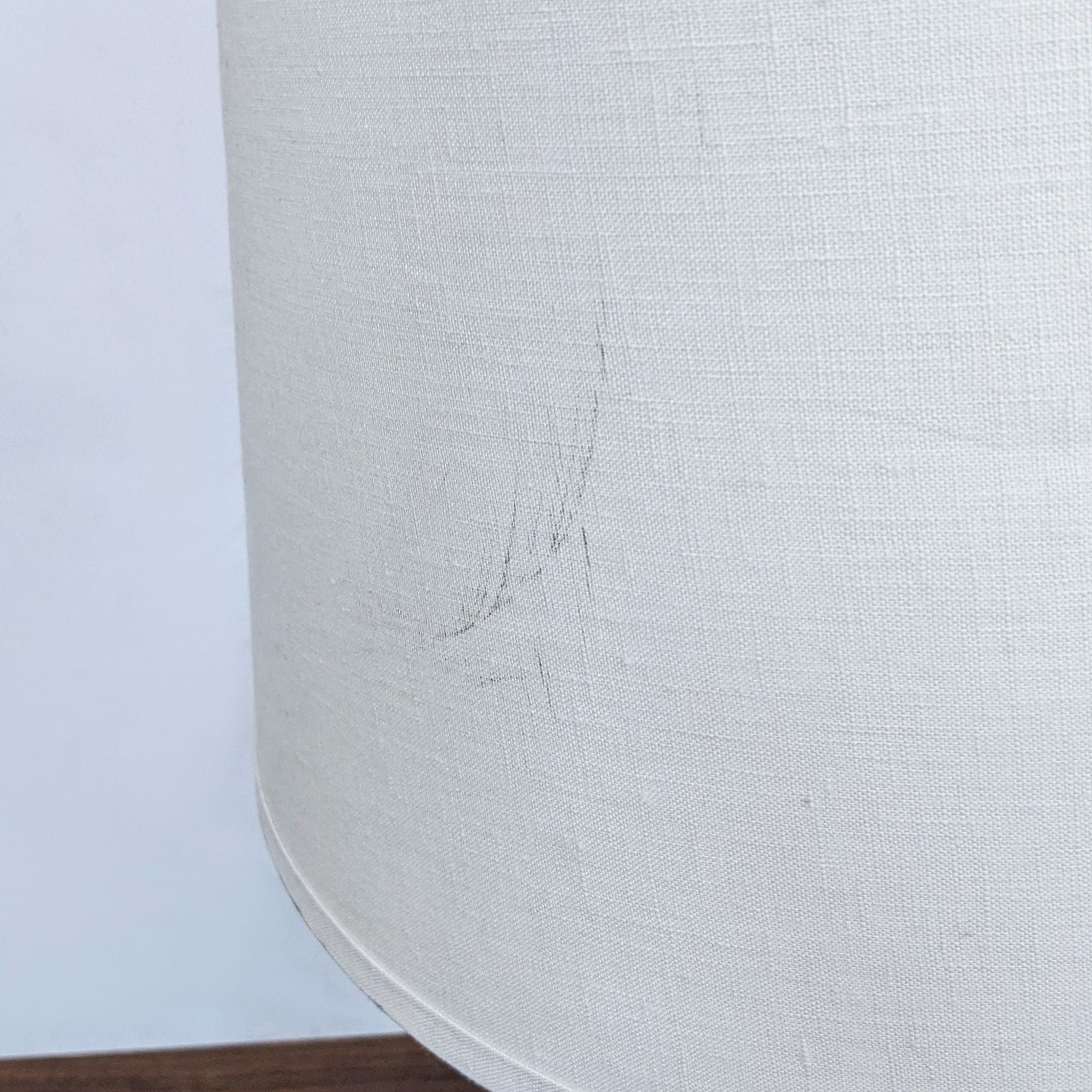 Close-up of a Reperch brand lampshade with a visible scratch on the fabric.