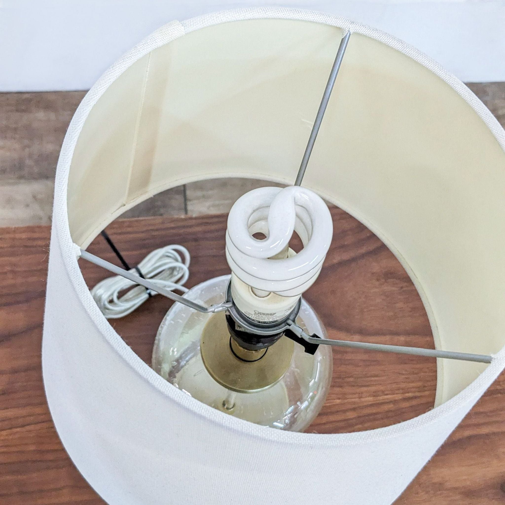 Top view of a Reperch lamp showing an energy-saving bulb and white fabric lampshade interior.
