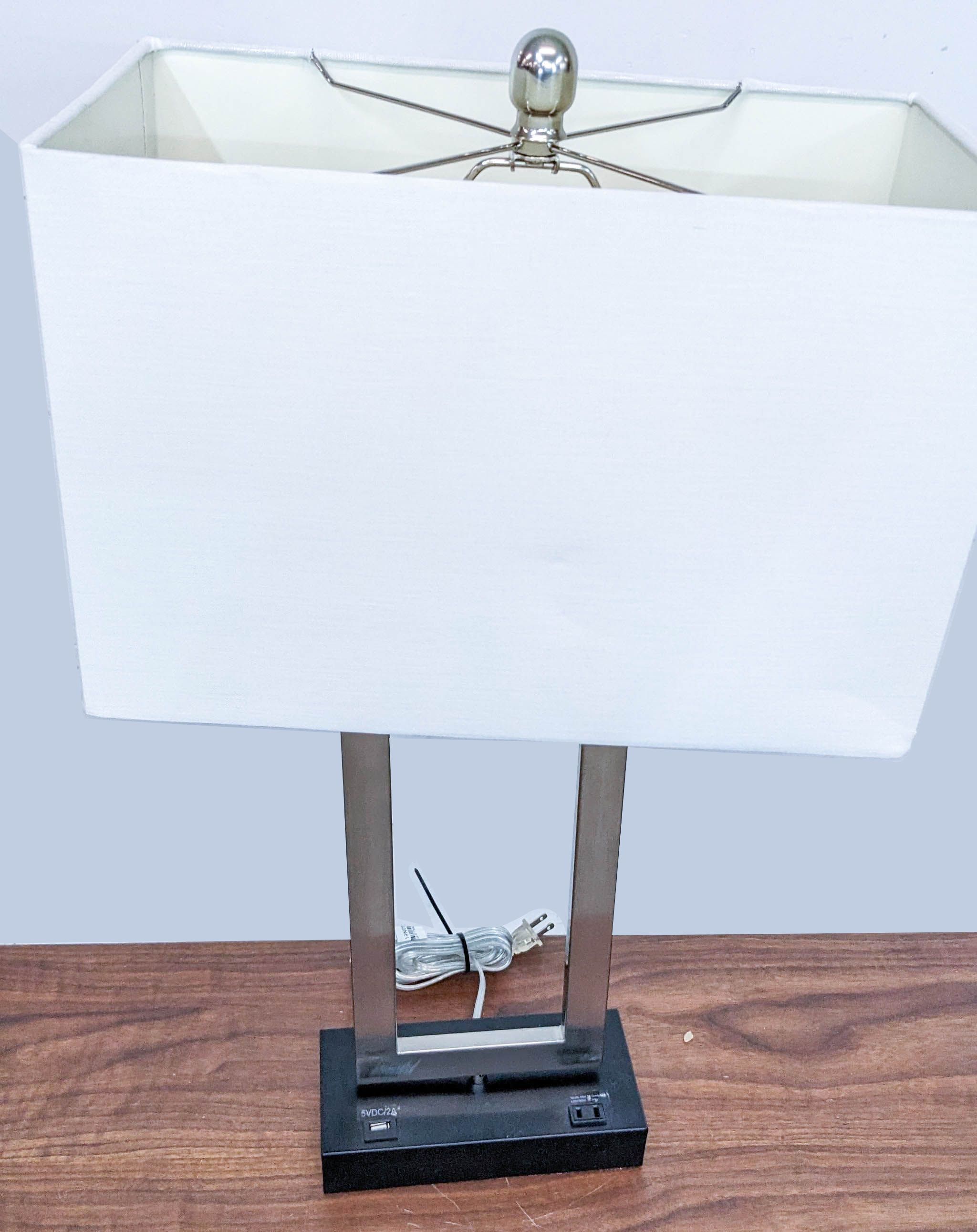 Reperch brand modern table lamp with a rectangular white shade and a metal frame on a wooden desk.