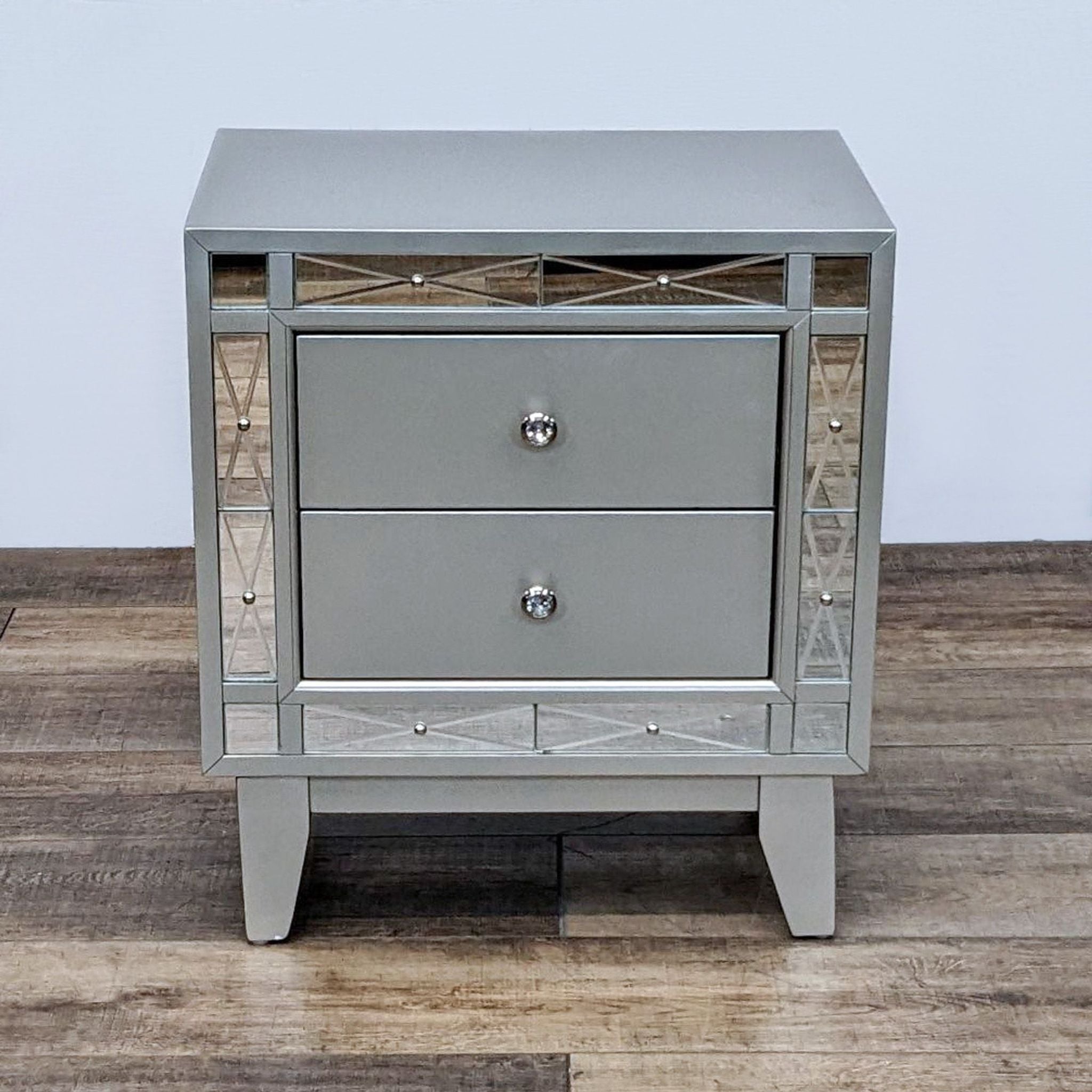 Metallic mercury finish nightstand with retro-inspired legs and etched mirror panels by Coaster Fine Furniture.
