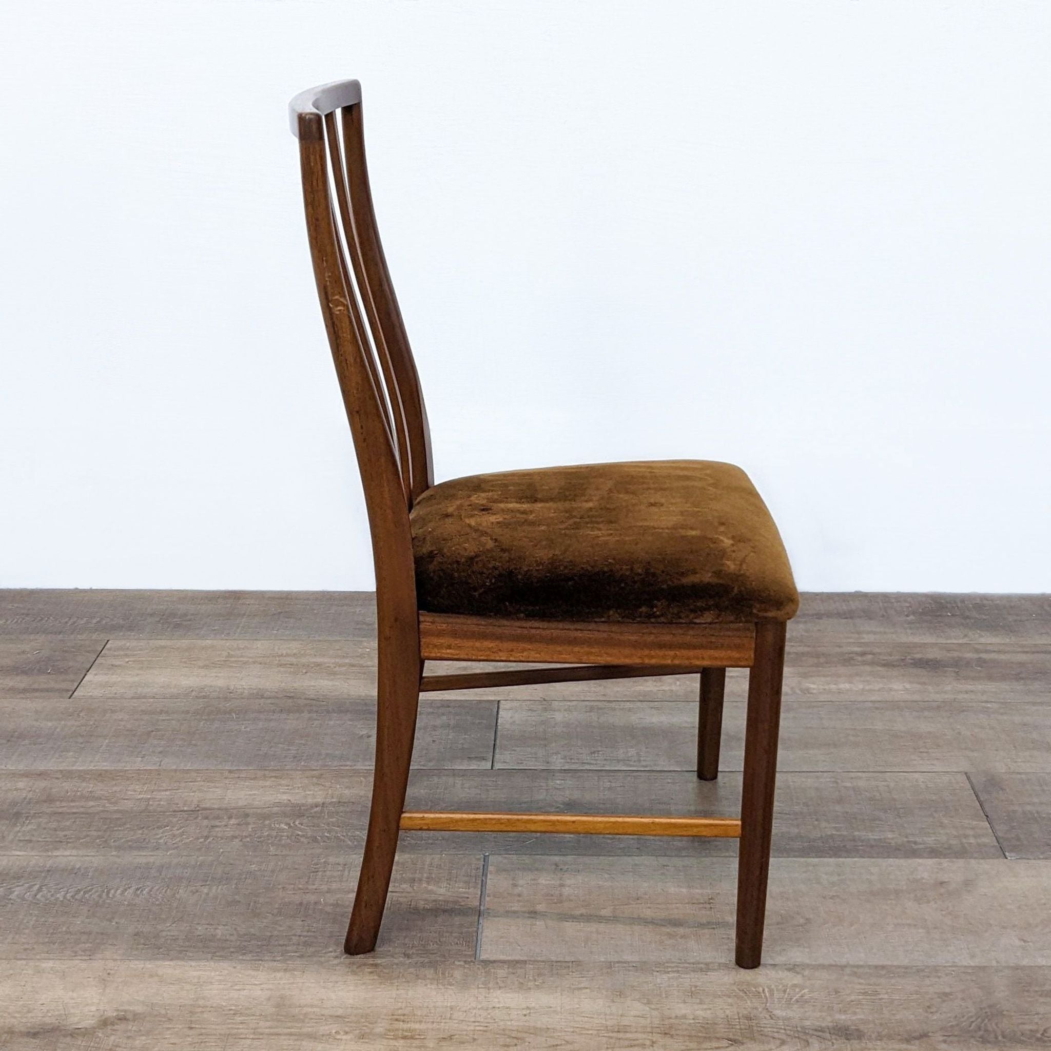 Side angle of a Reperch transitional wooden dining chair with vertical slats and cushioned seat in brown velvet fabric.