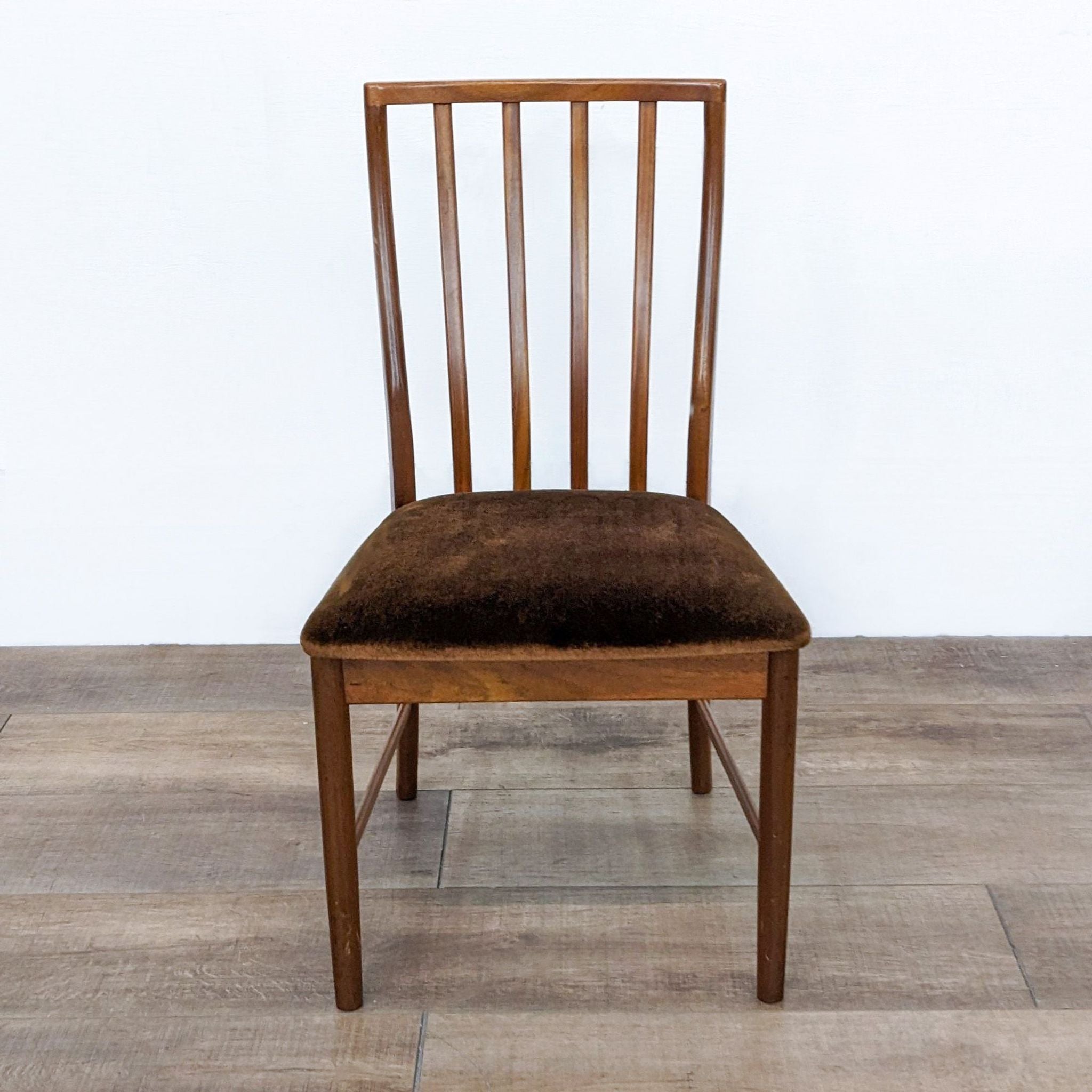 Reperch transitional dining chair with wooden slat back and cushioned seat in brown velvet fabric, on a wooden floor.