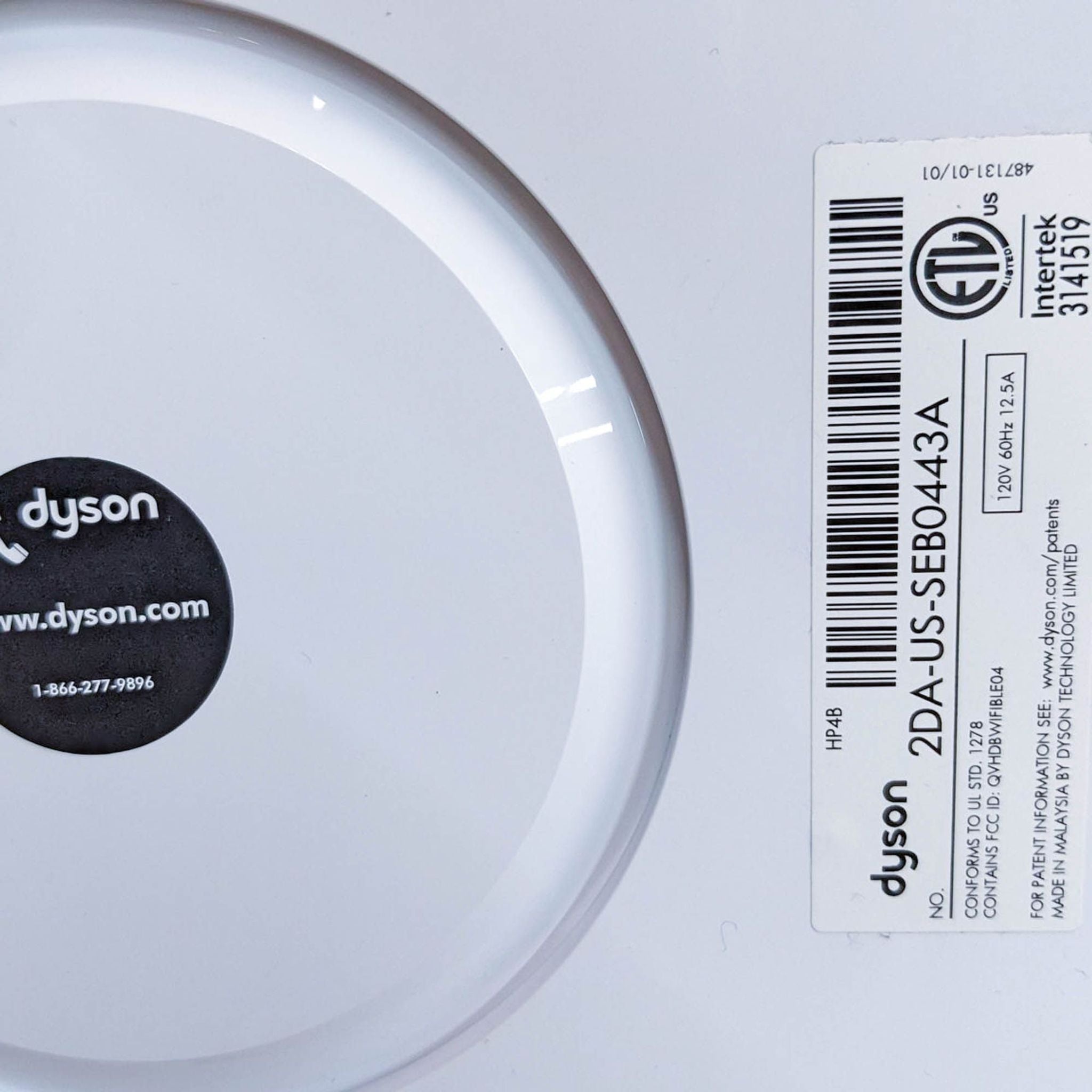 Label showing Dyson brand and model details on the base of the Purifier Cool Gen1 TP10, with a website and contact number.